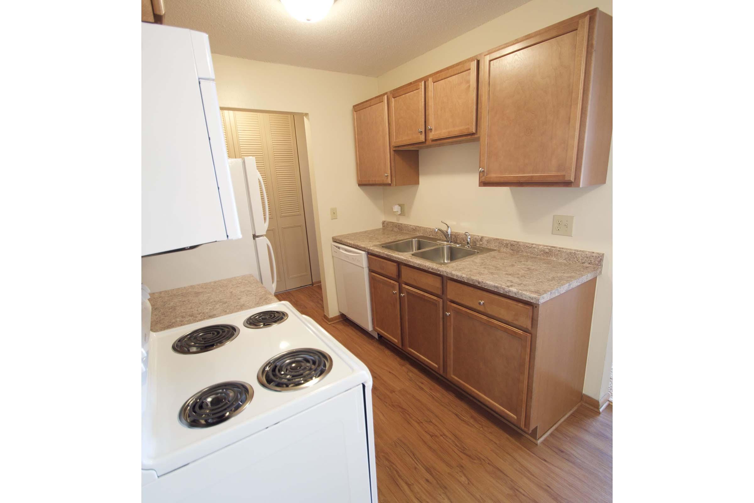 a stove top oven sitting inside of a kitchen