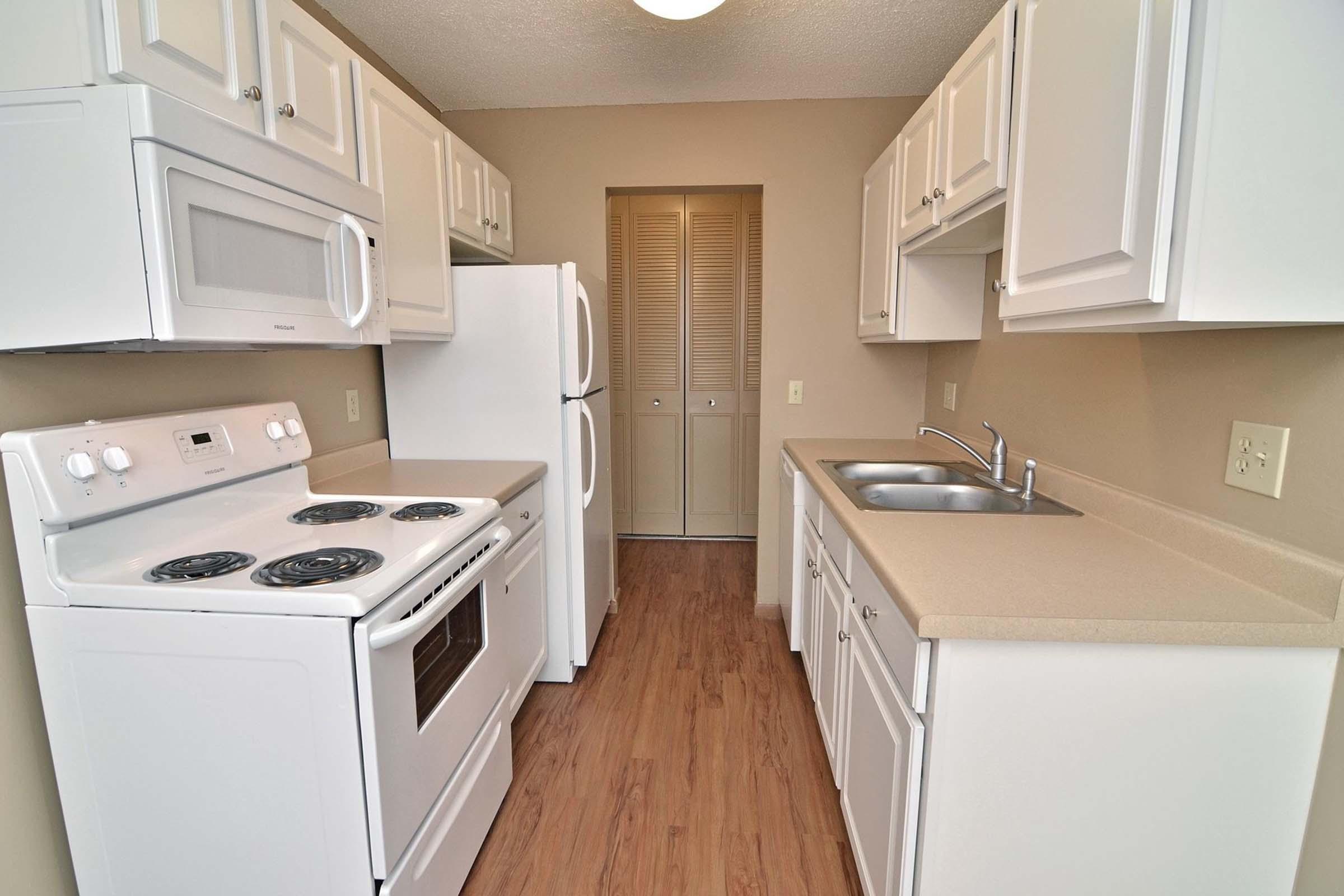 a kitchen with a stove top oven sitting inside of a refrigerator