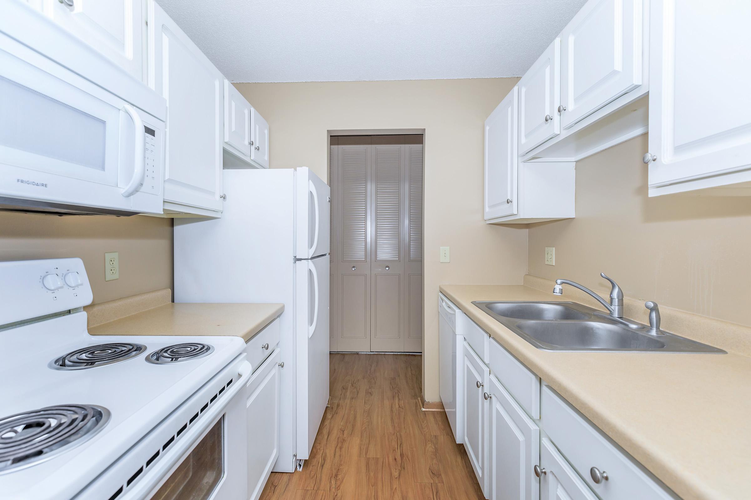 a kitchen with a stove a sink and a microwave