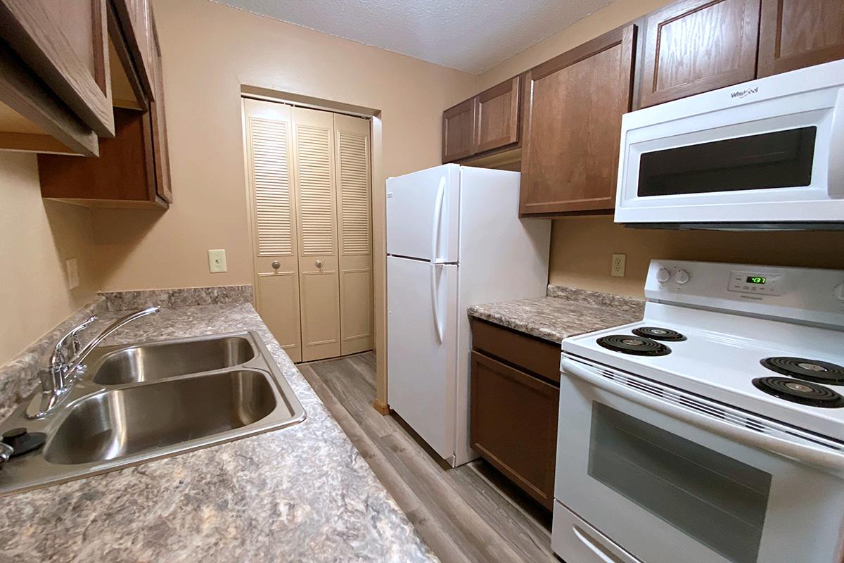 a stove top oven sitting inside of a kitchen