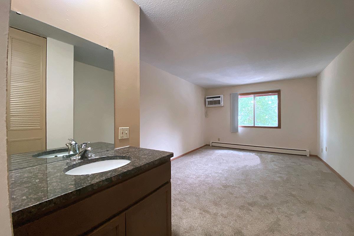 a kitchen with a sink and a mirror