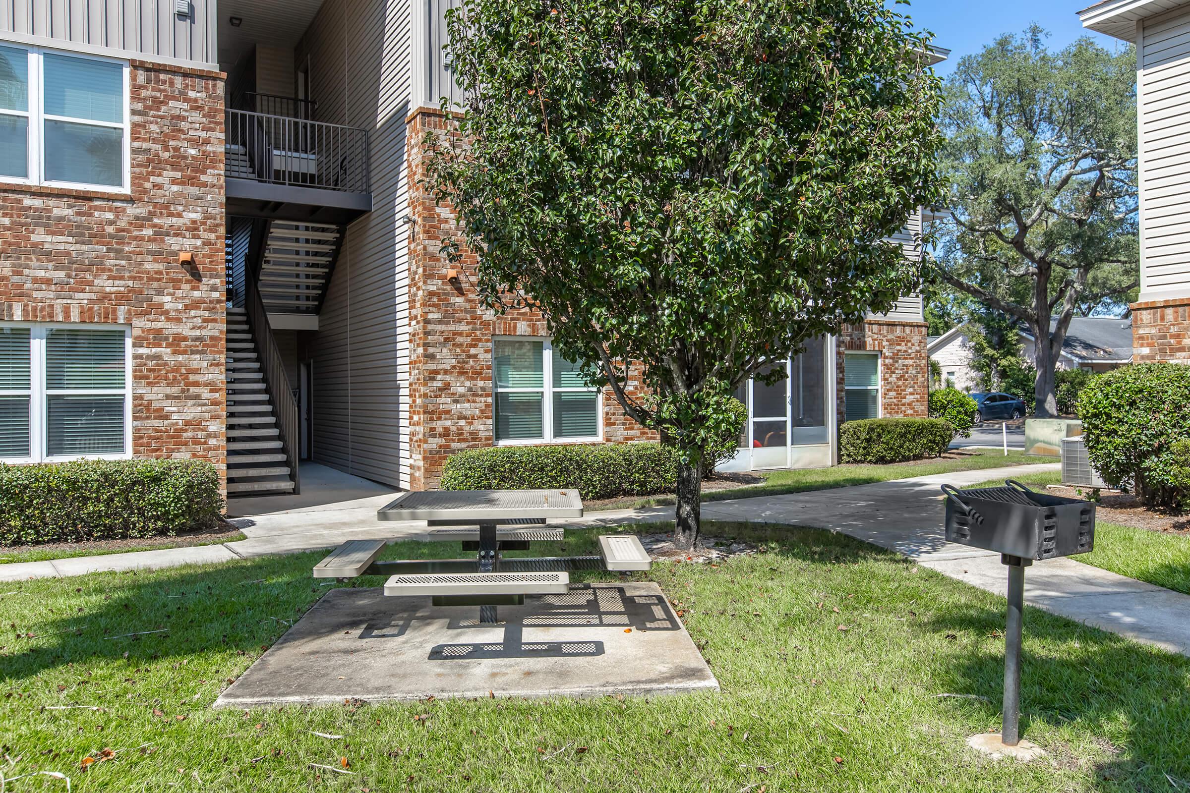 a large lawn in front of a brick building