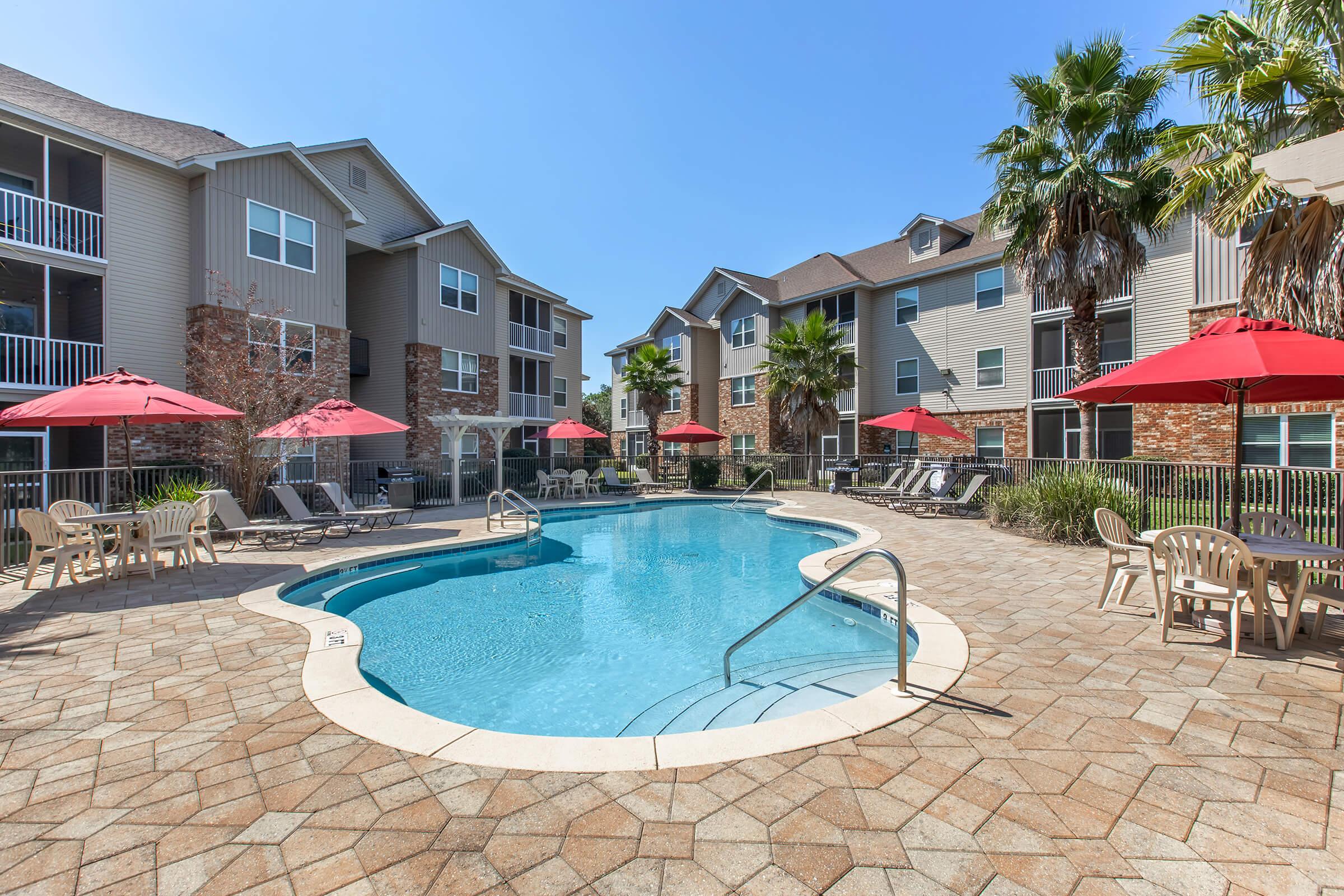 a house with a pool in front of a building