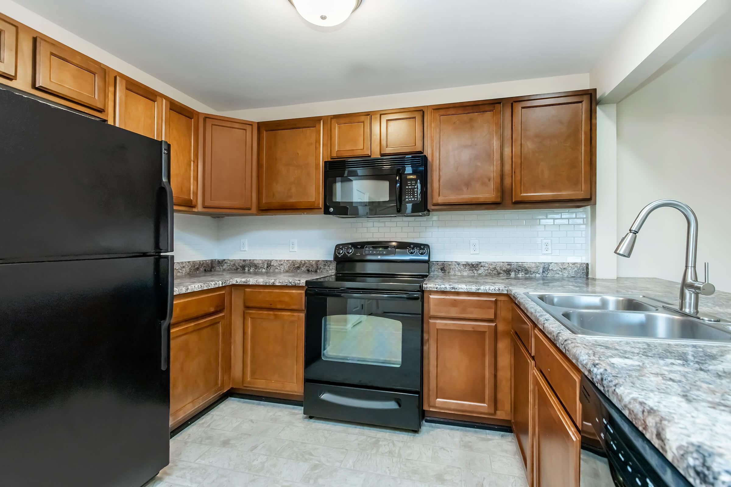 a kitchen with stainless steel appliances and wooden cabinets