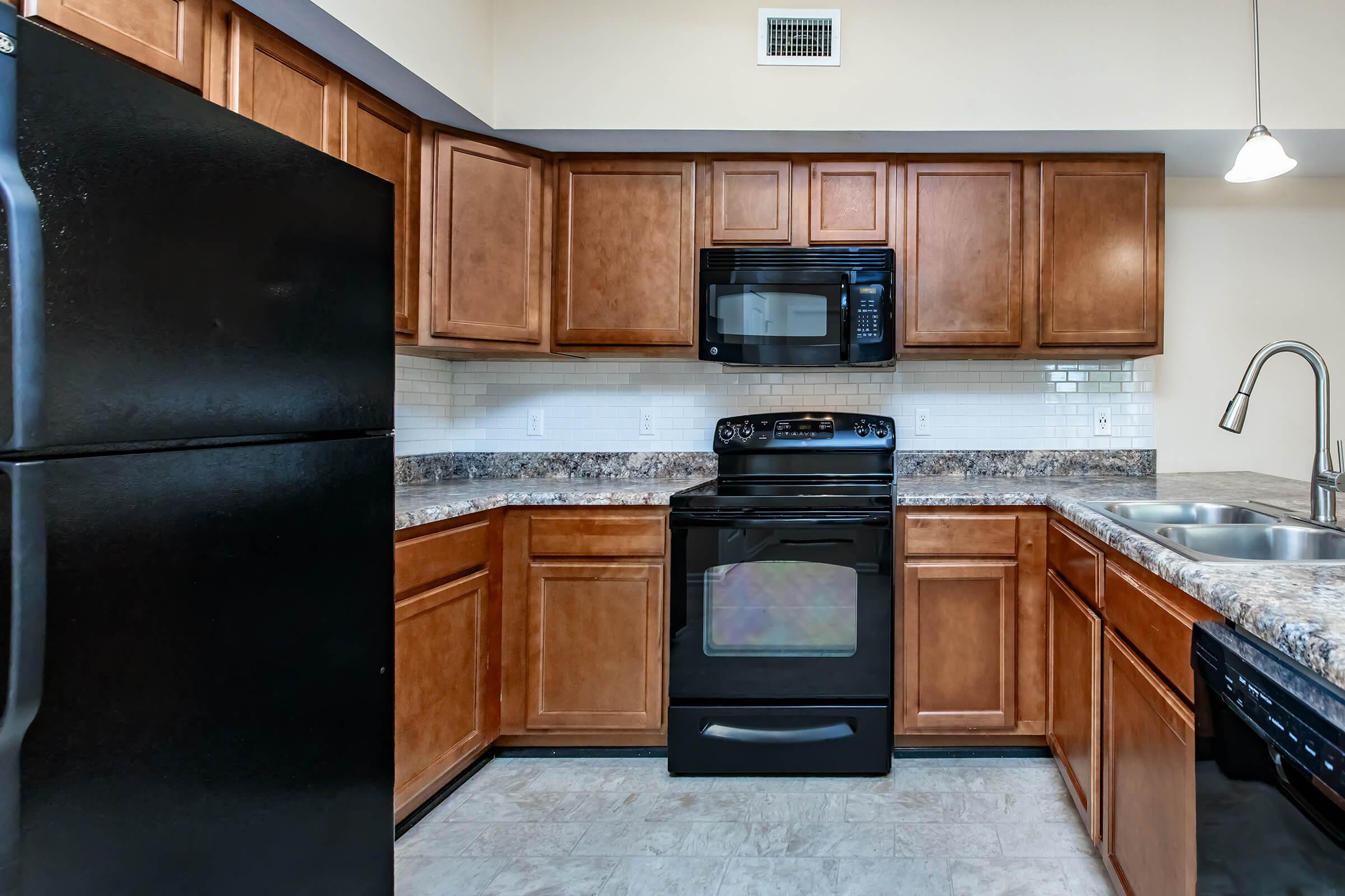 a kitchen with stainless steel appliances and wooden cabinets