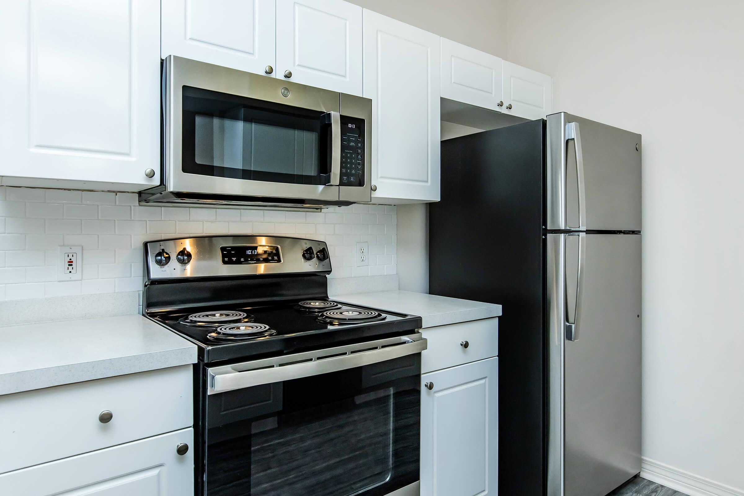 a stove top oven sitting inside of a kitchen