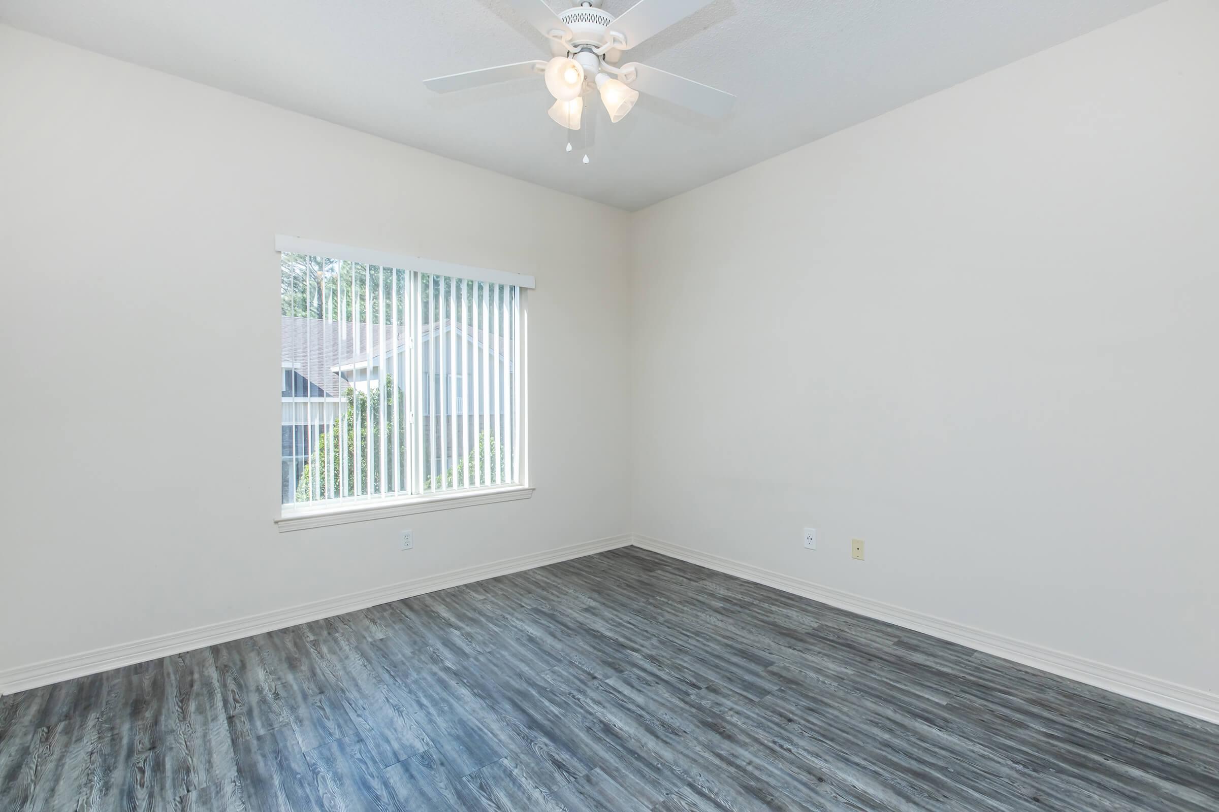 a bedroom with a wooden floor