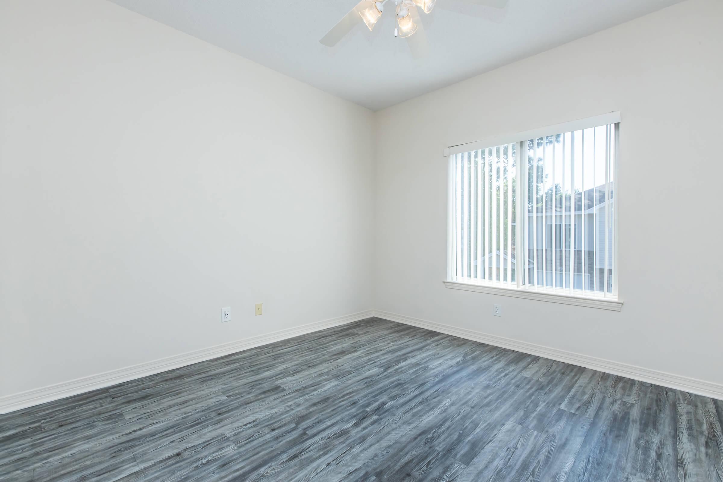 a bedroom with a wooden floor