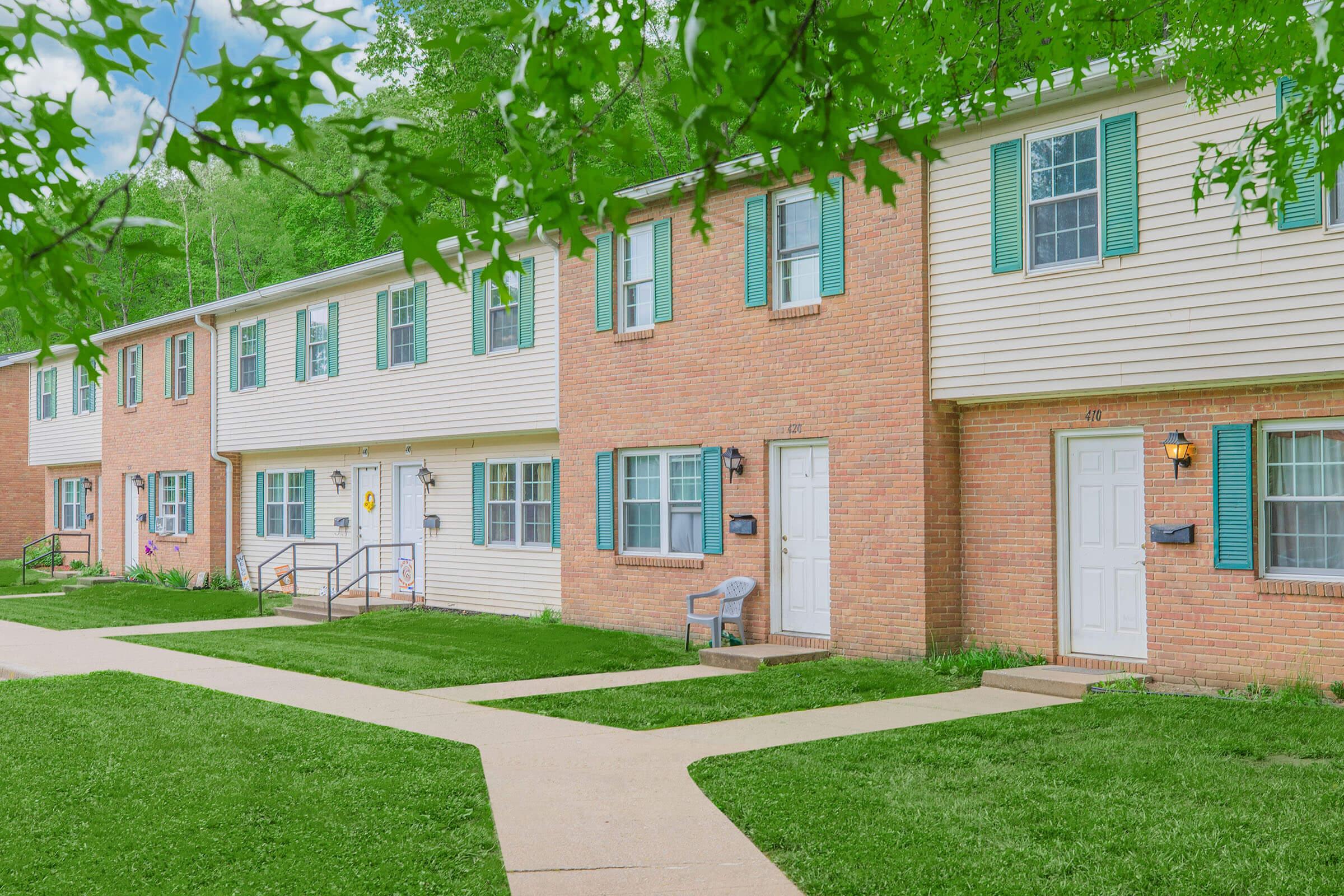 a large lawn in front of a brick building