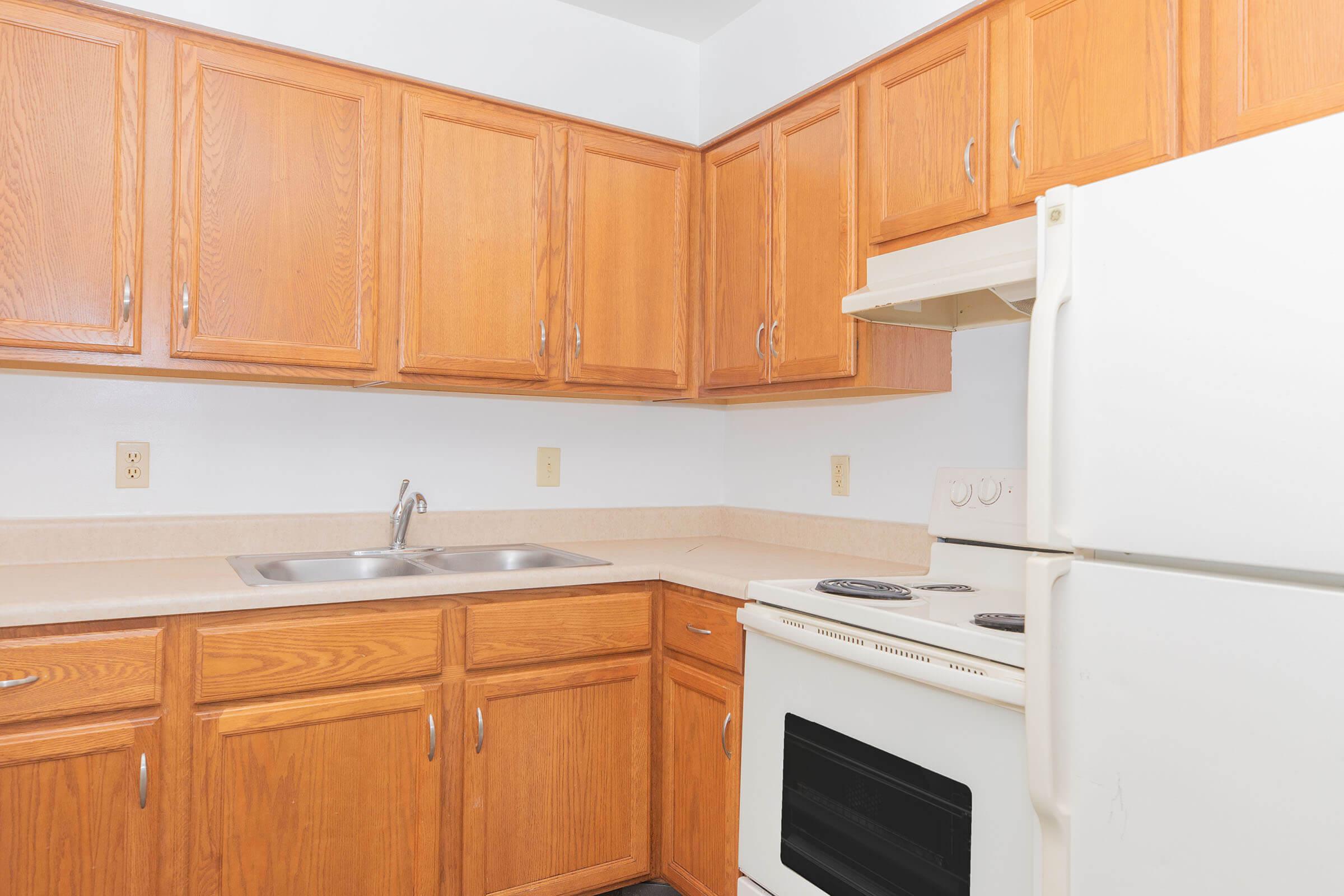 a kitchen with wooden cabinets and a microwave