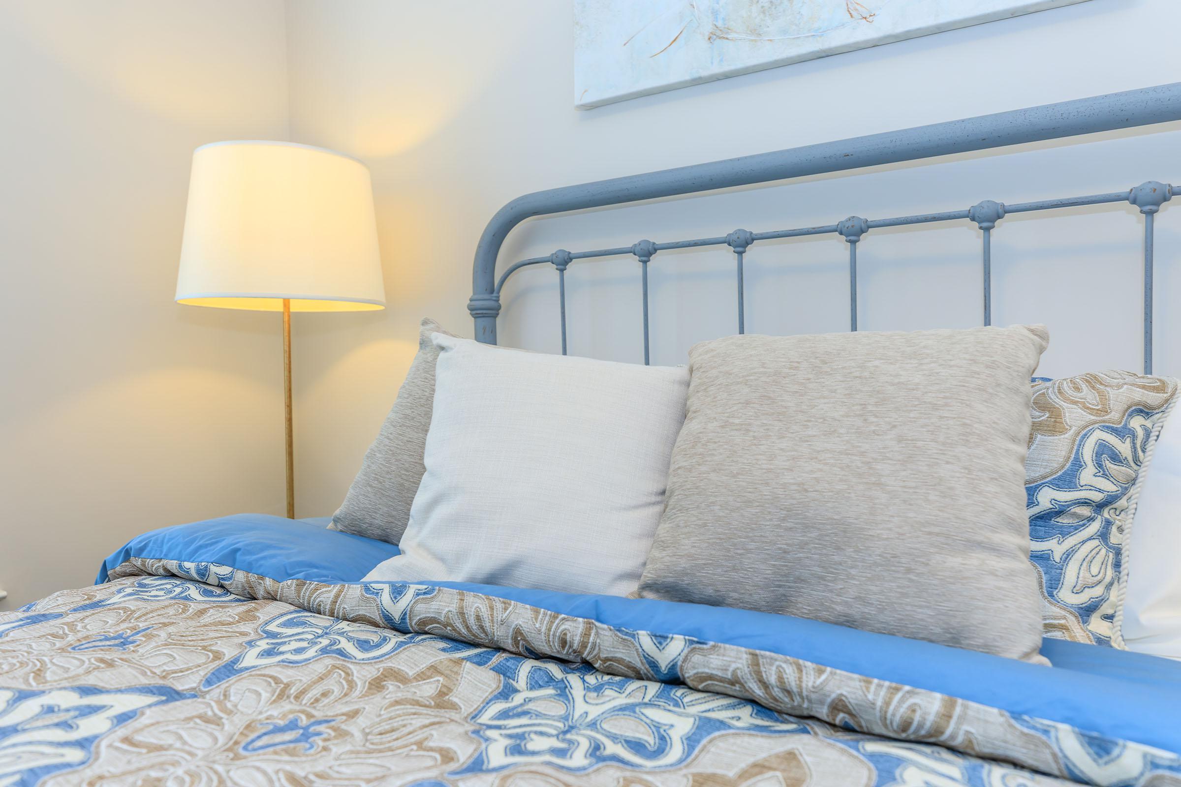 a double bed with a blue blanket