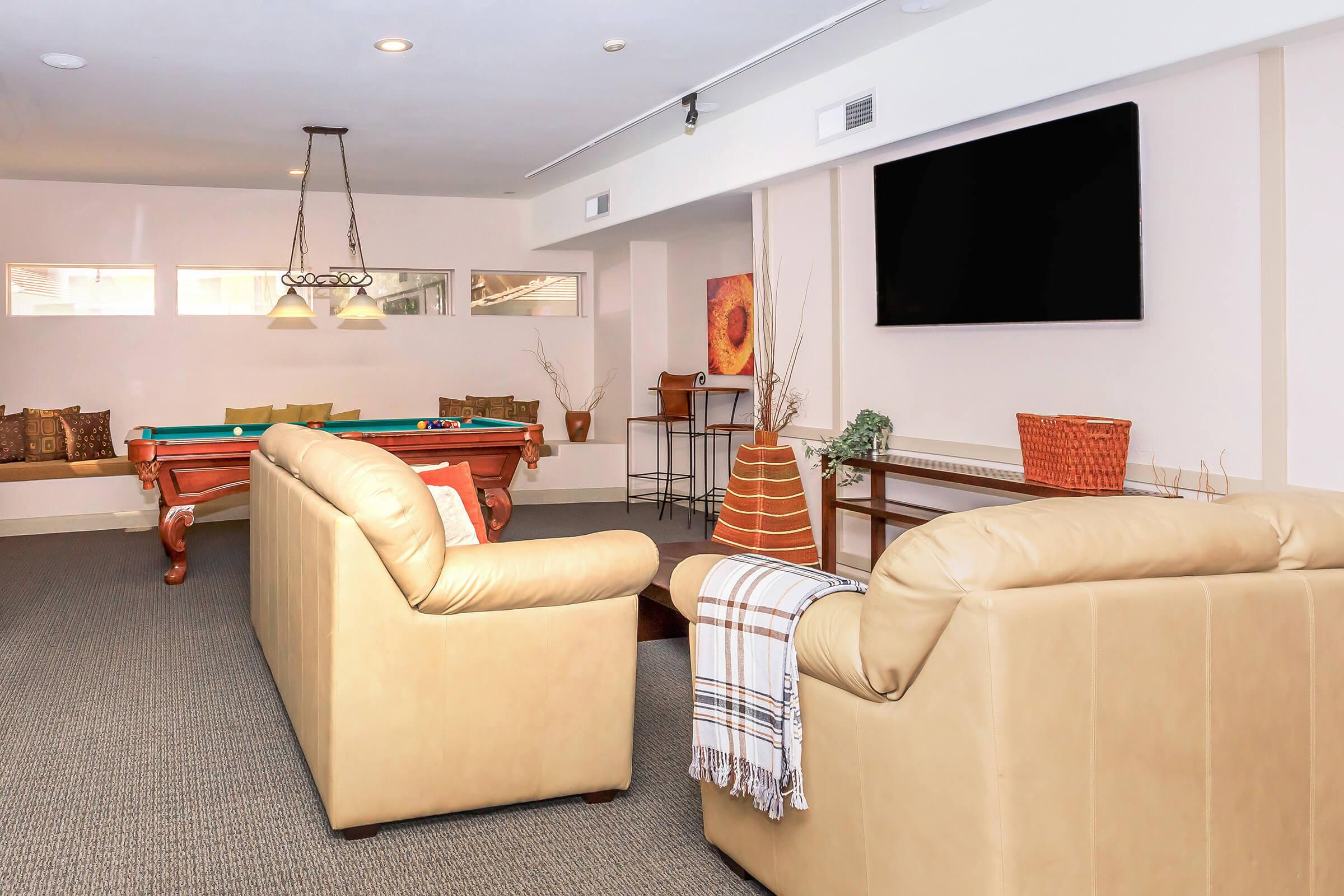 a living room filled with furniture and a flat screen tv