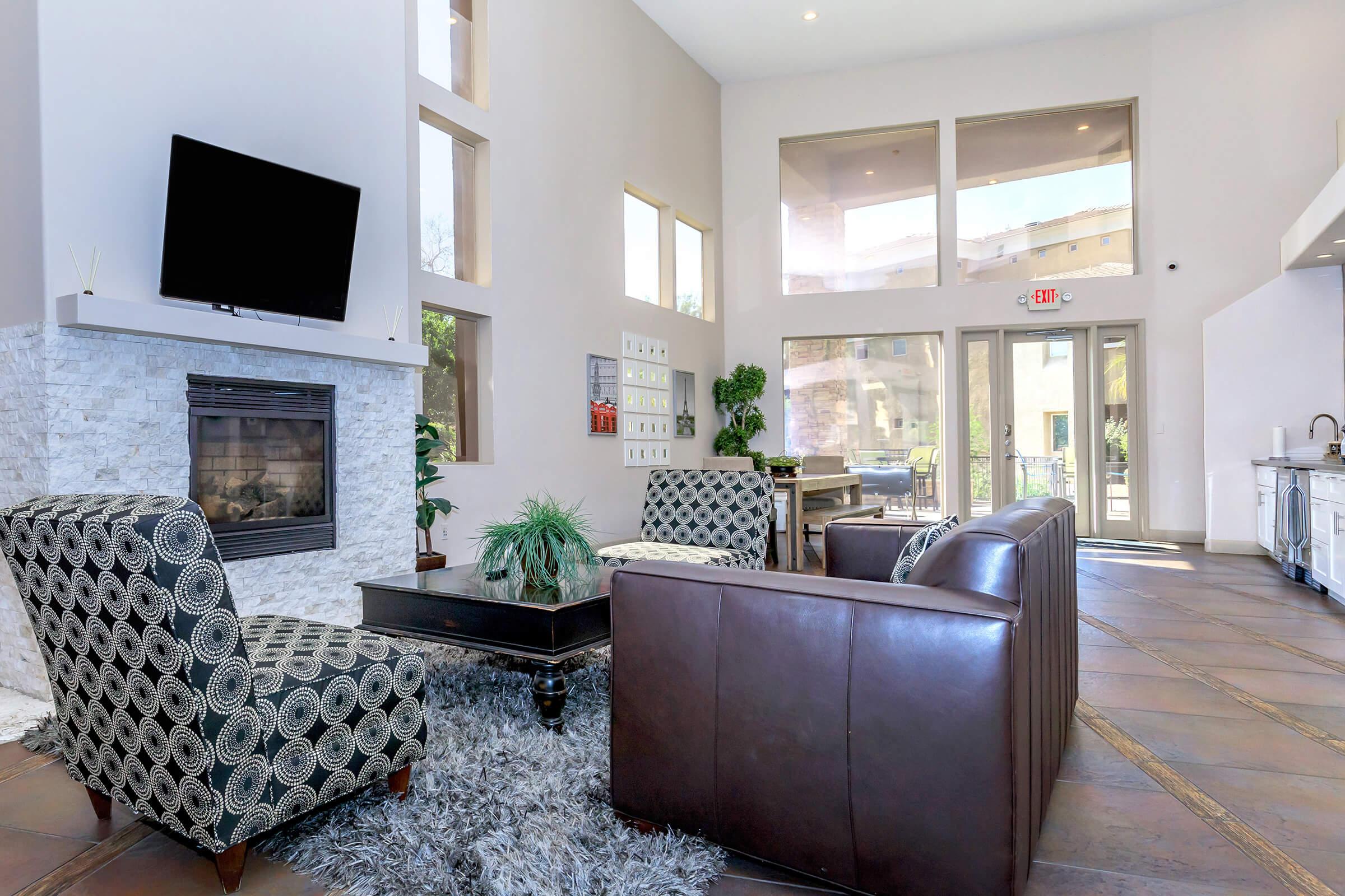 a living room filled with furniture and a large window