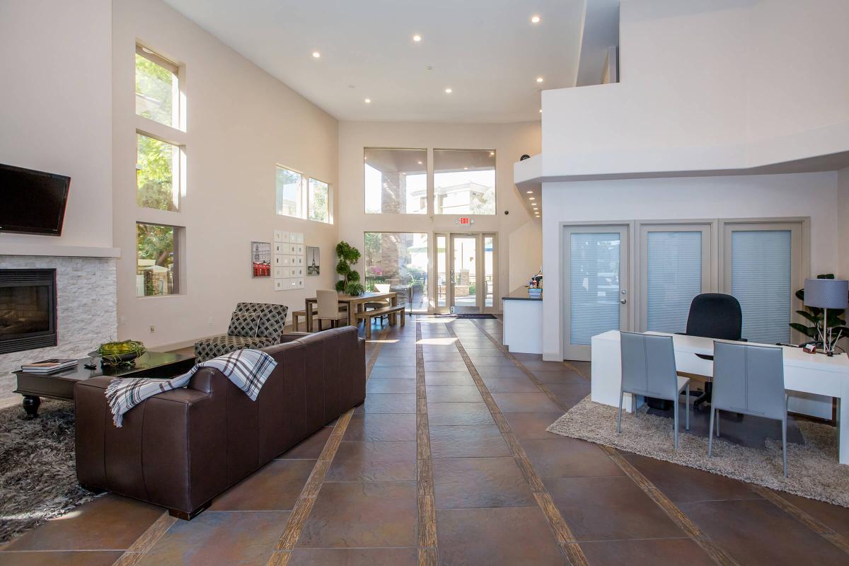 a living room filled with furniture and a large window