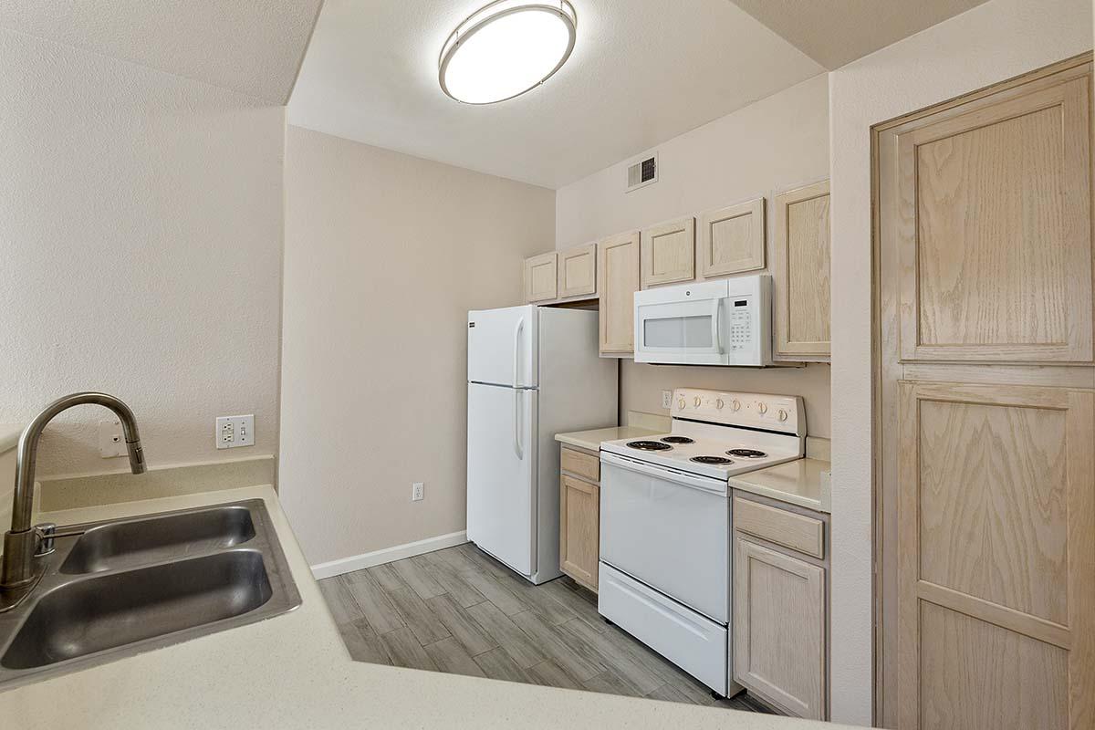 a kitchen with a sink and a refrigerator