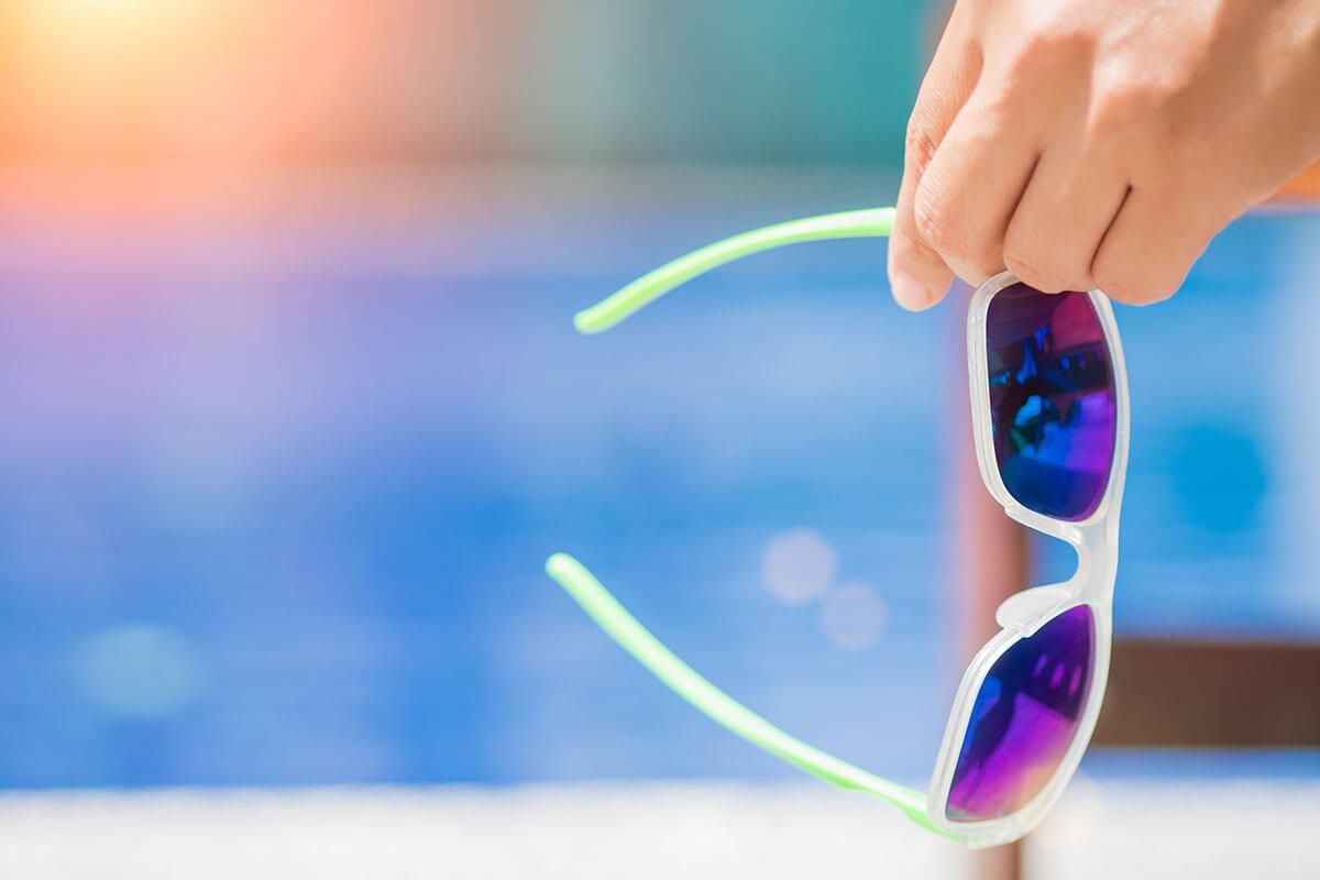 Woman hand holding sunglasses iStock-831868398.jpg