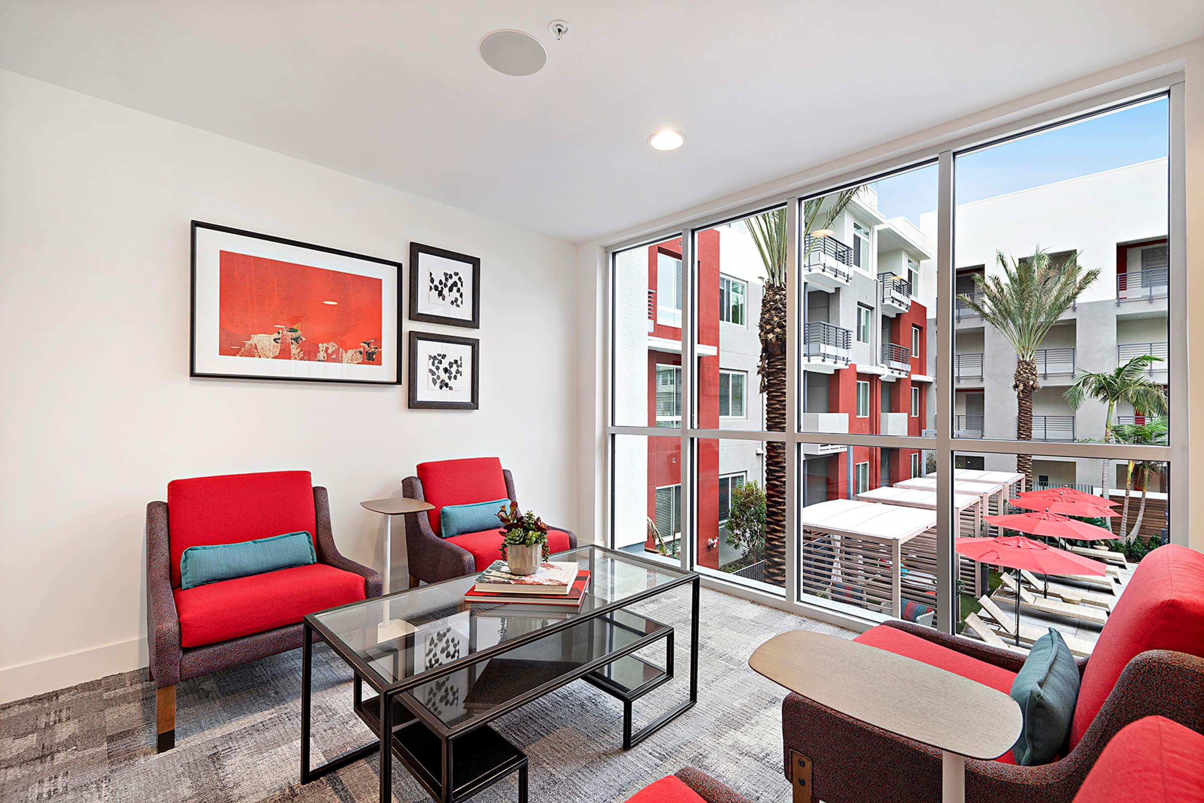 a living room filled with furniture and a large window