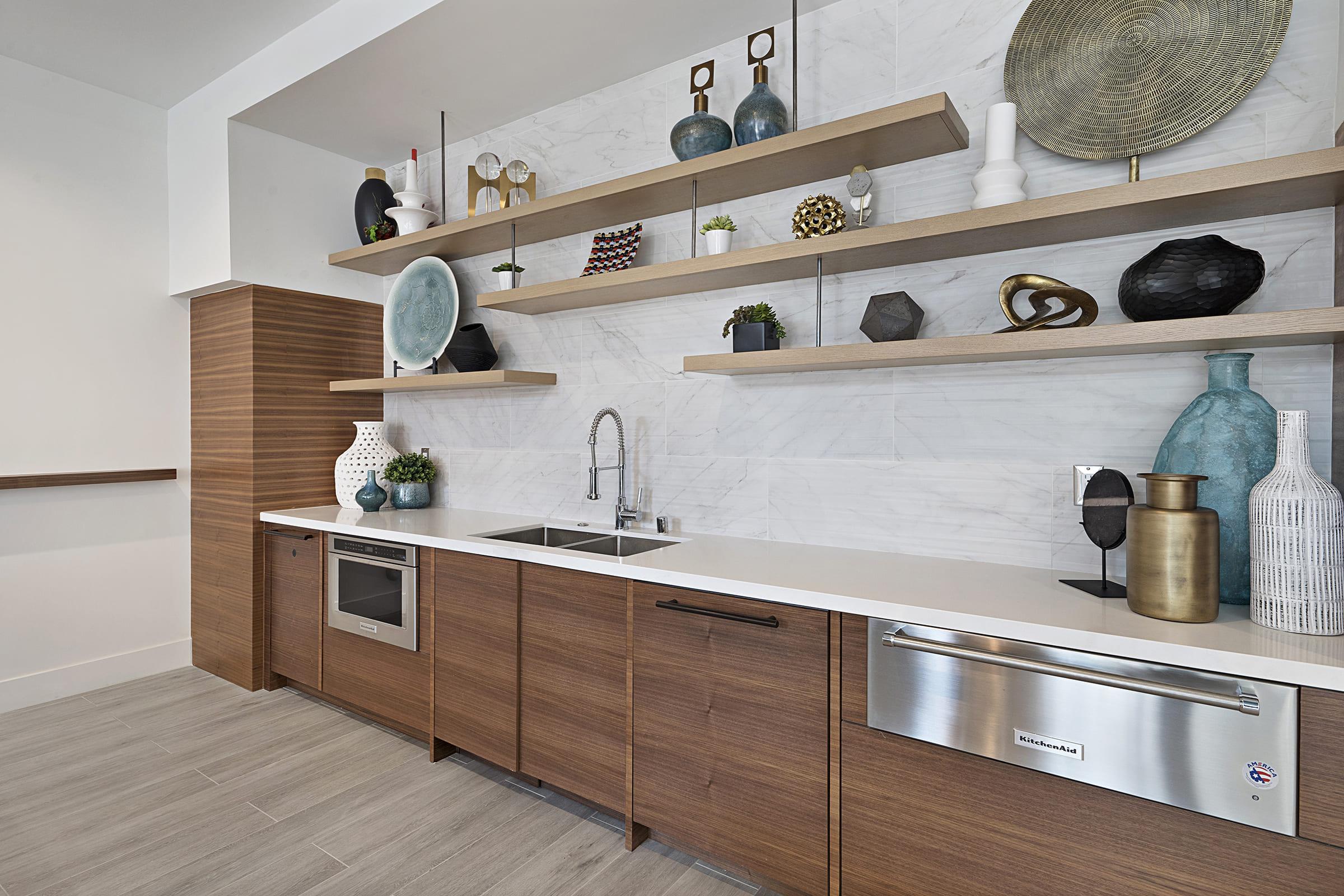 a kitchen with a sink and a mirror