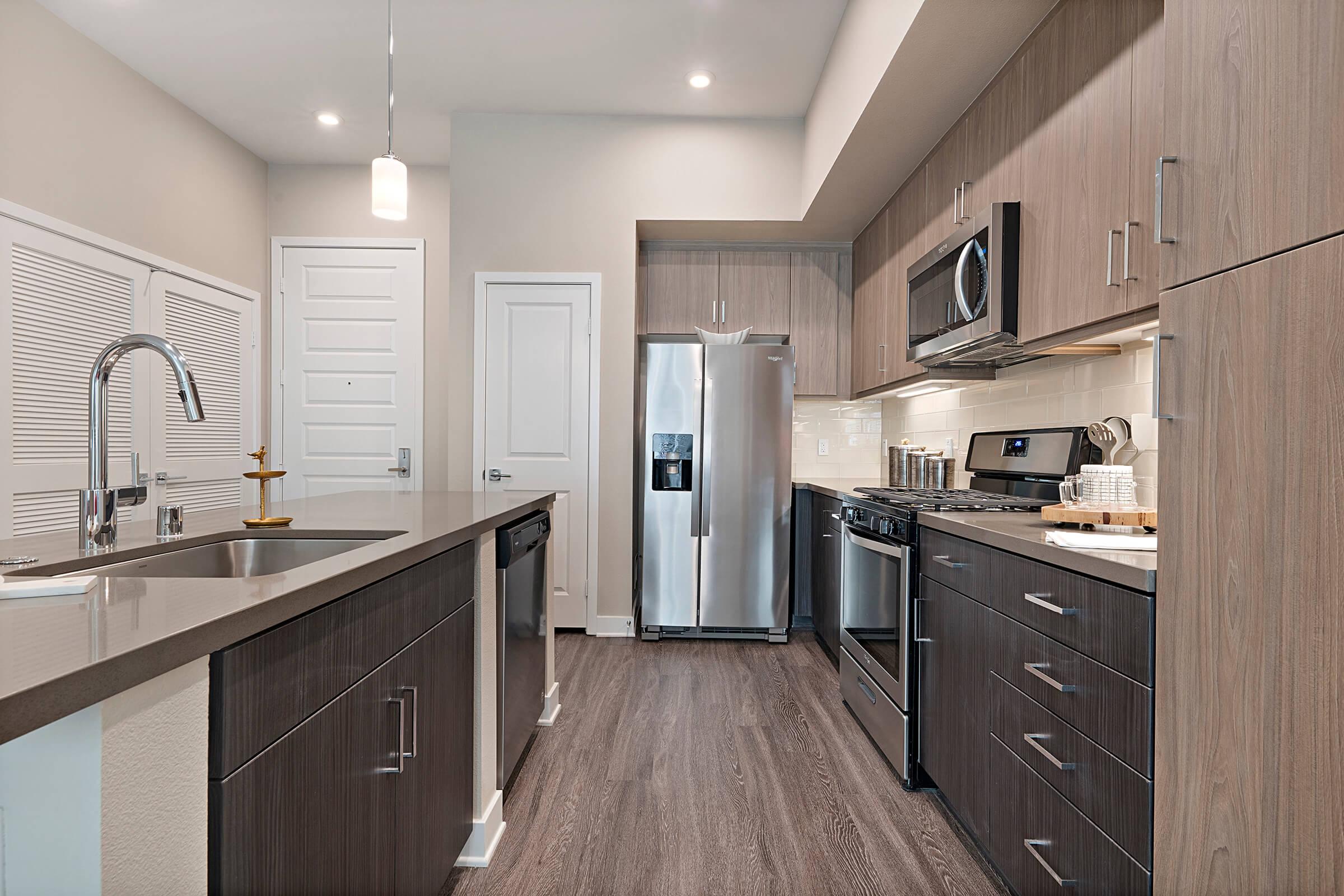 a kitchen with a sink and a mirror