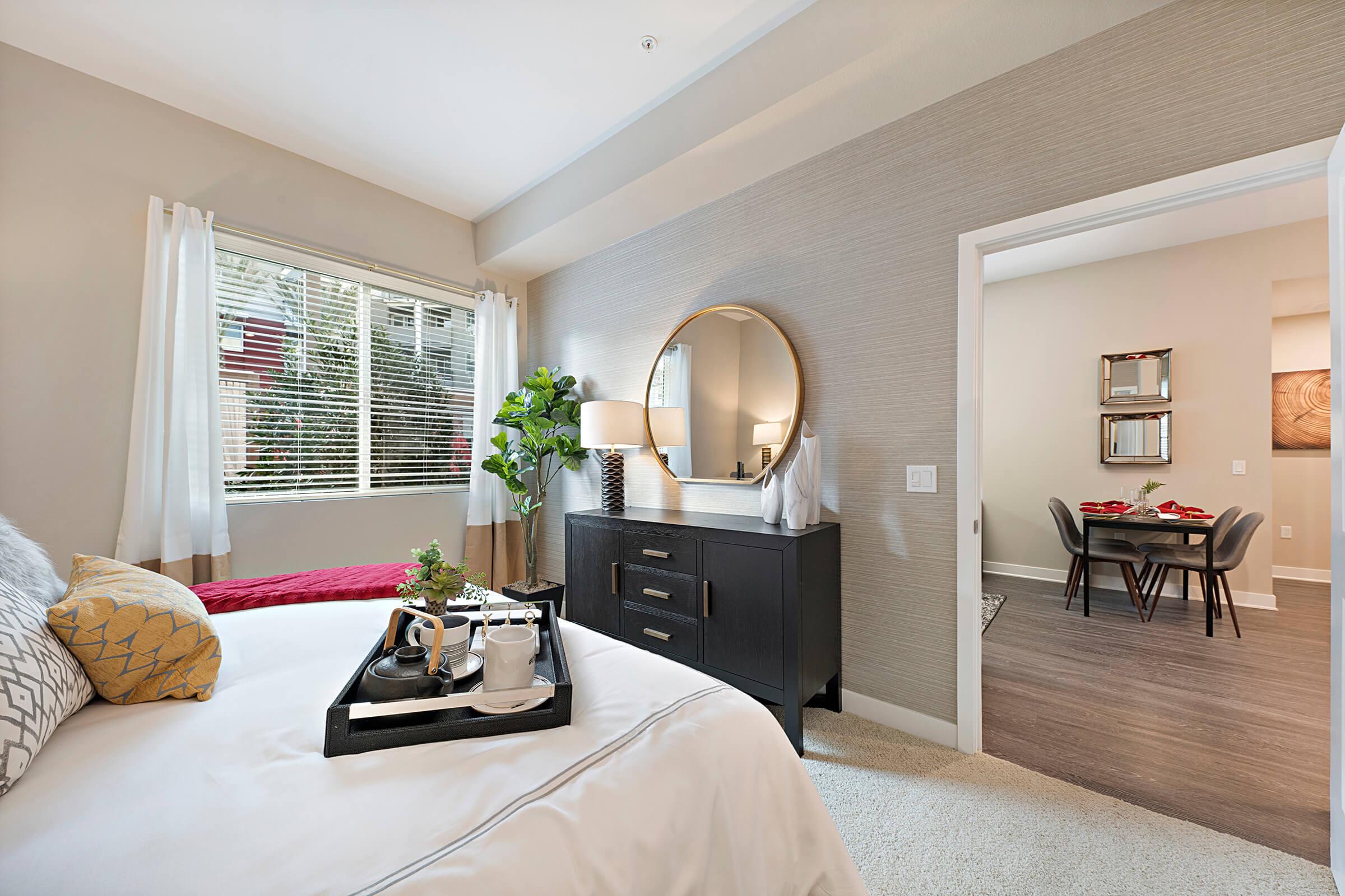 a bedroom with a large bed sitting in a living room