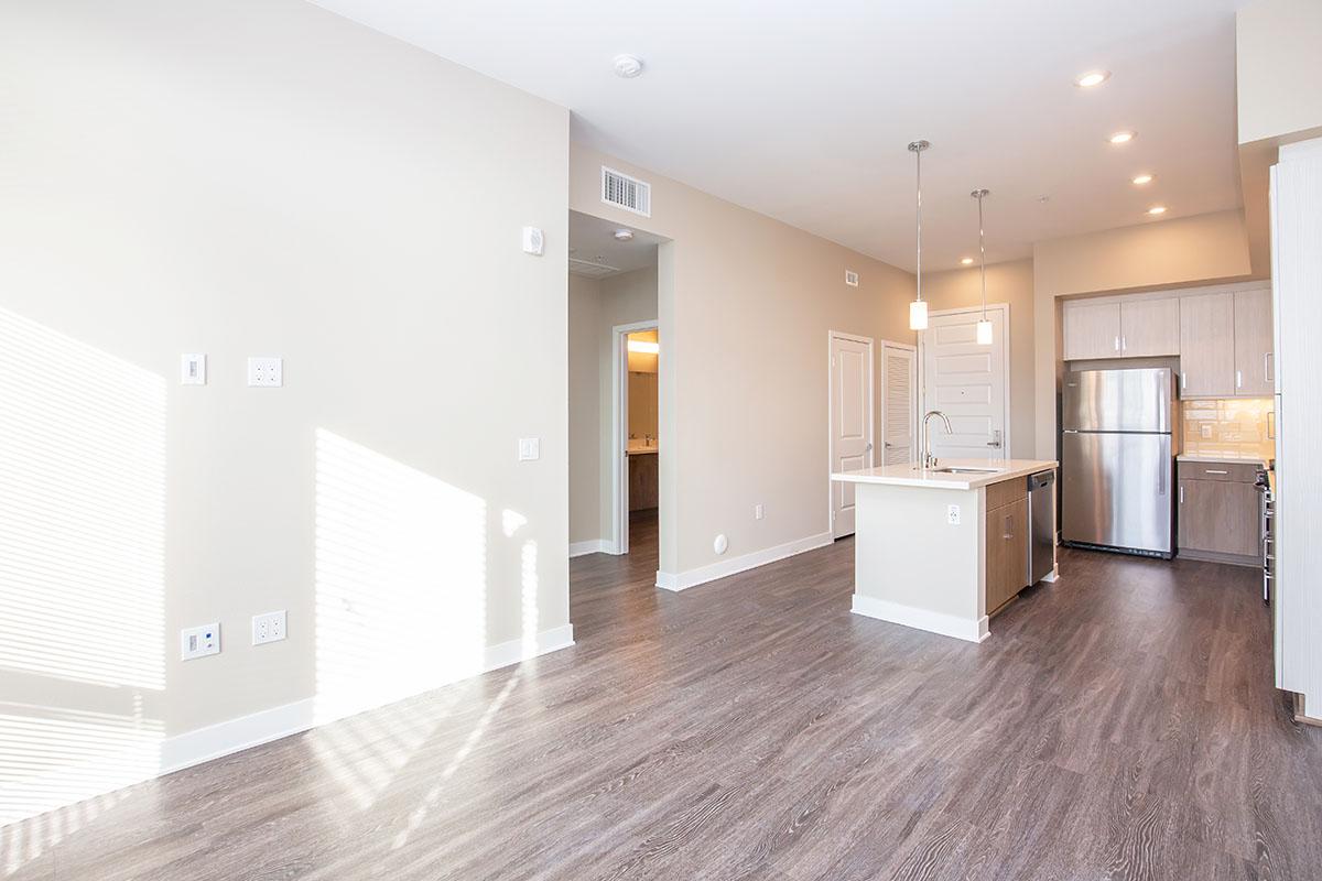 Unfurnished living room and kitchen with wooden floors