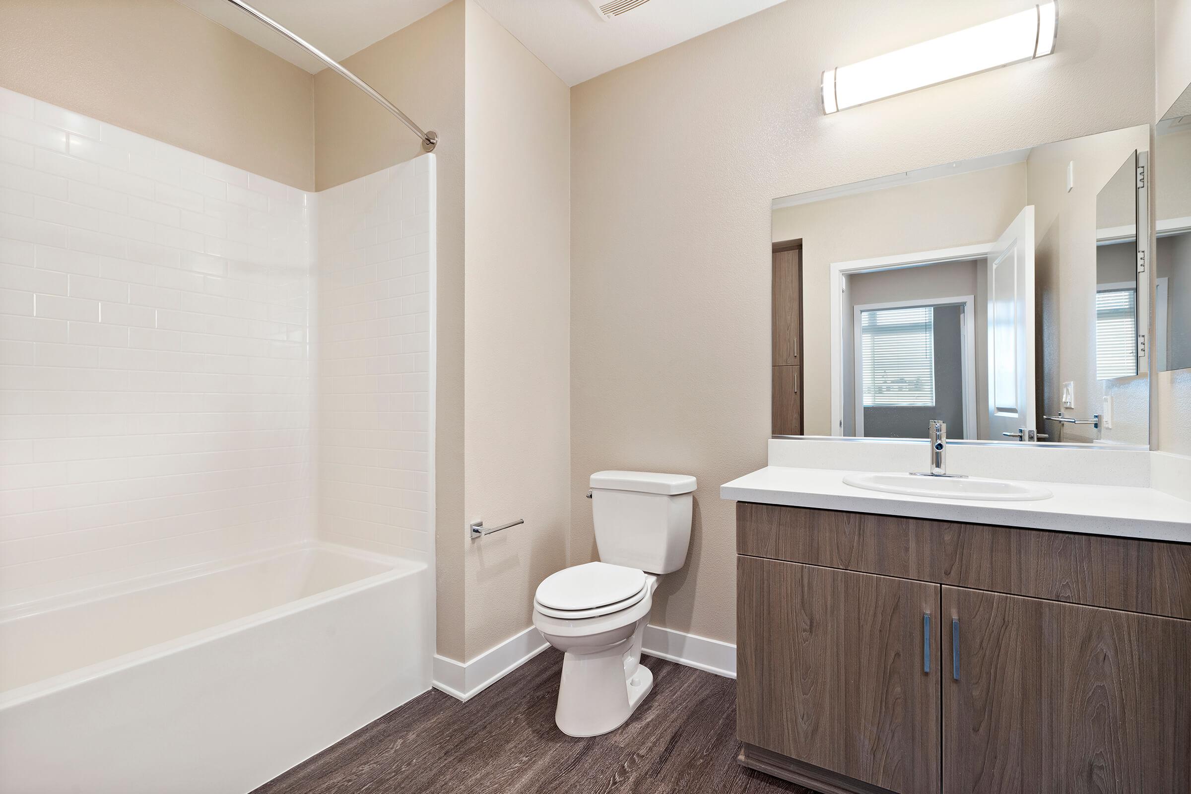 Unfurnished bathroom with wooden cabinets