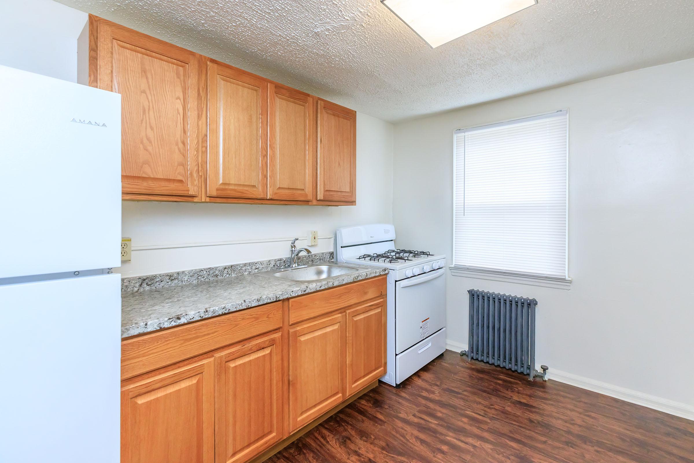 a kitchen with stainless steel appliances and wooden cabinets