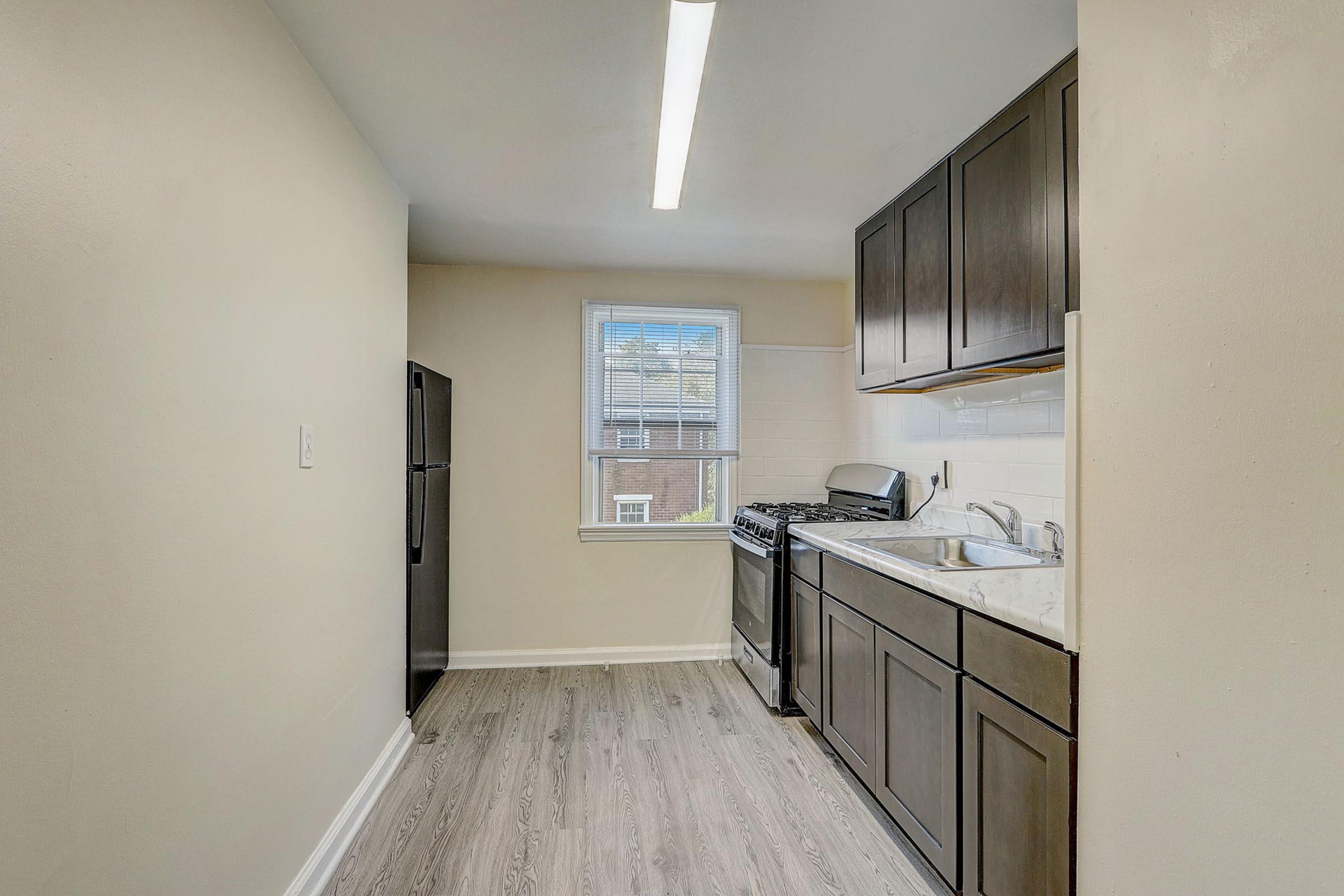 a kitchen with a sink and a refrigerator