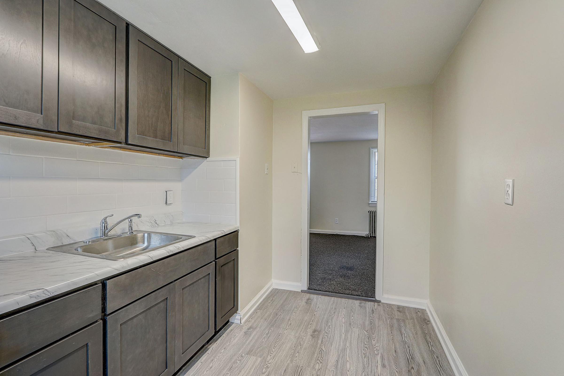 a kitchen with a sink and a mirror