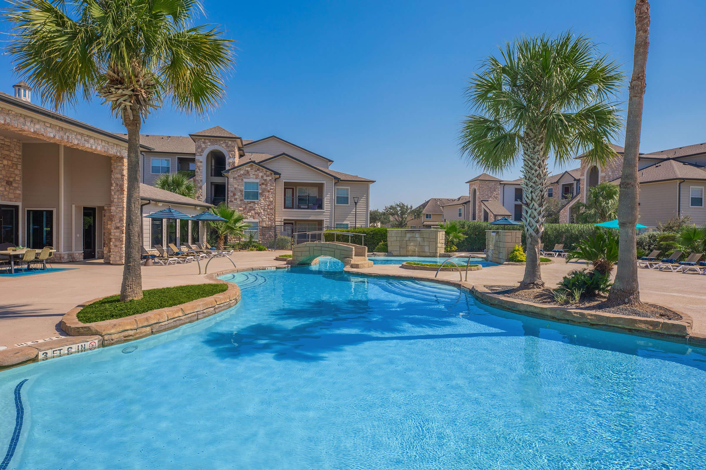 a large pool of water in front of a house