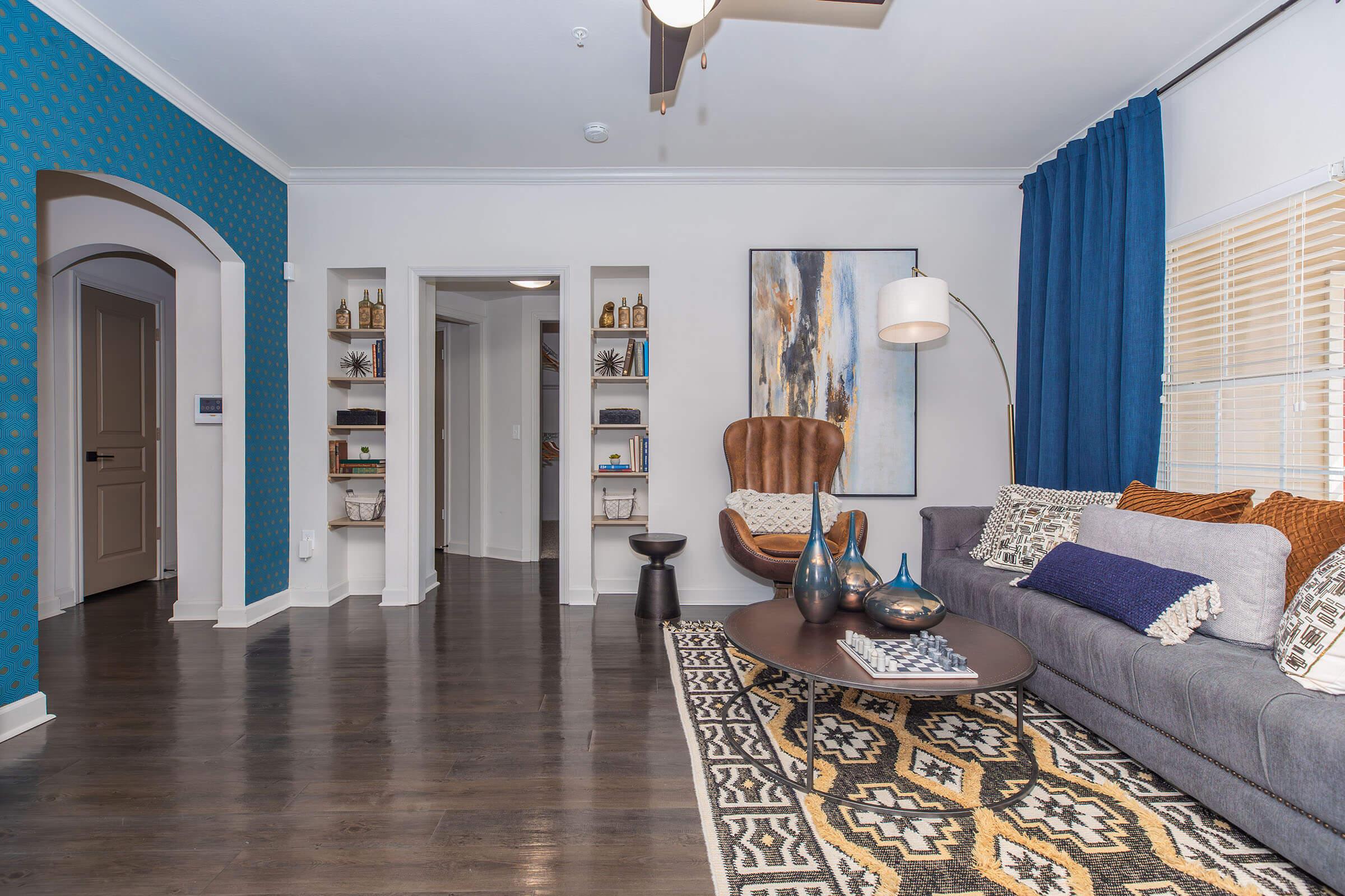 a living room filled with furniture and a rug