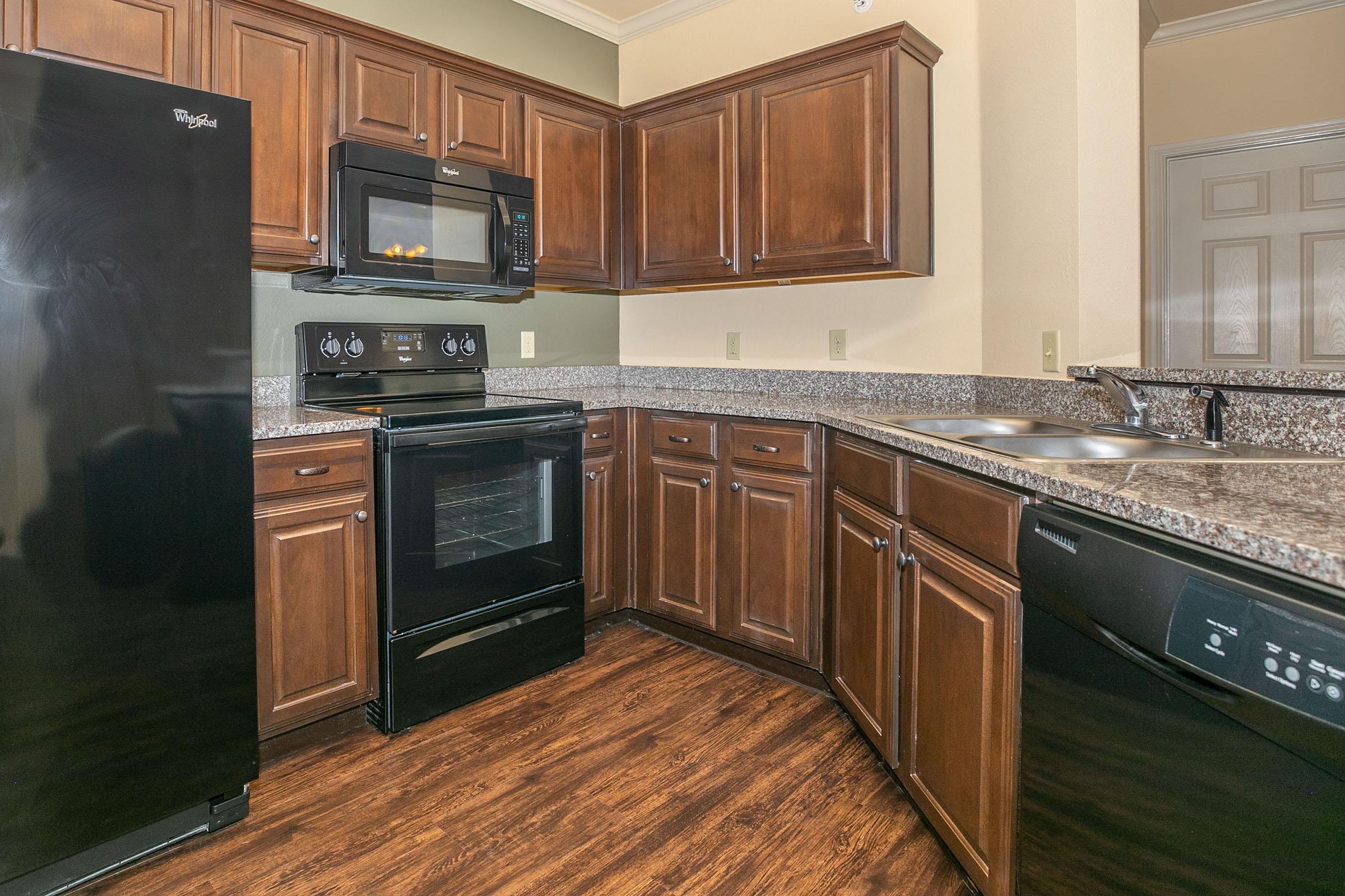 a kitchen with stainless steel appliances and wooden cabinets