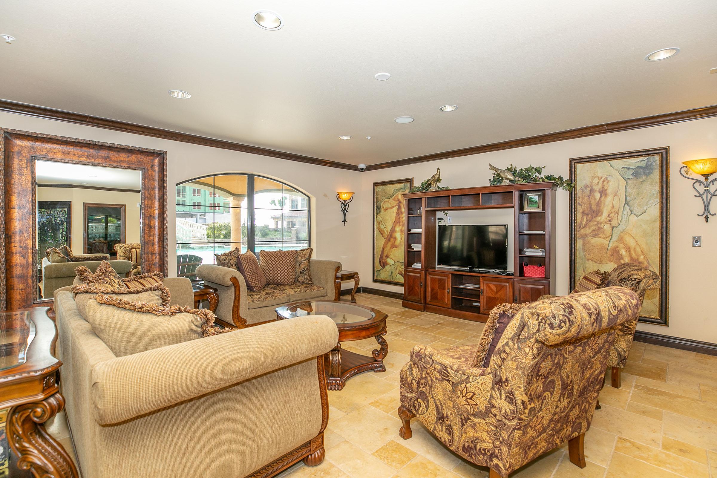 a living room filled with furniture and a flat screen tv