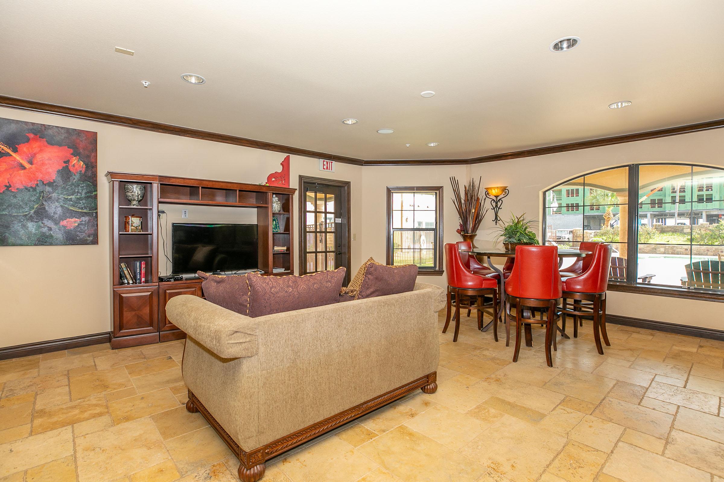 a living room filled with furniture and a large window