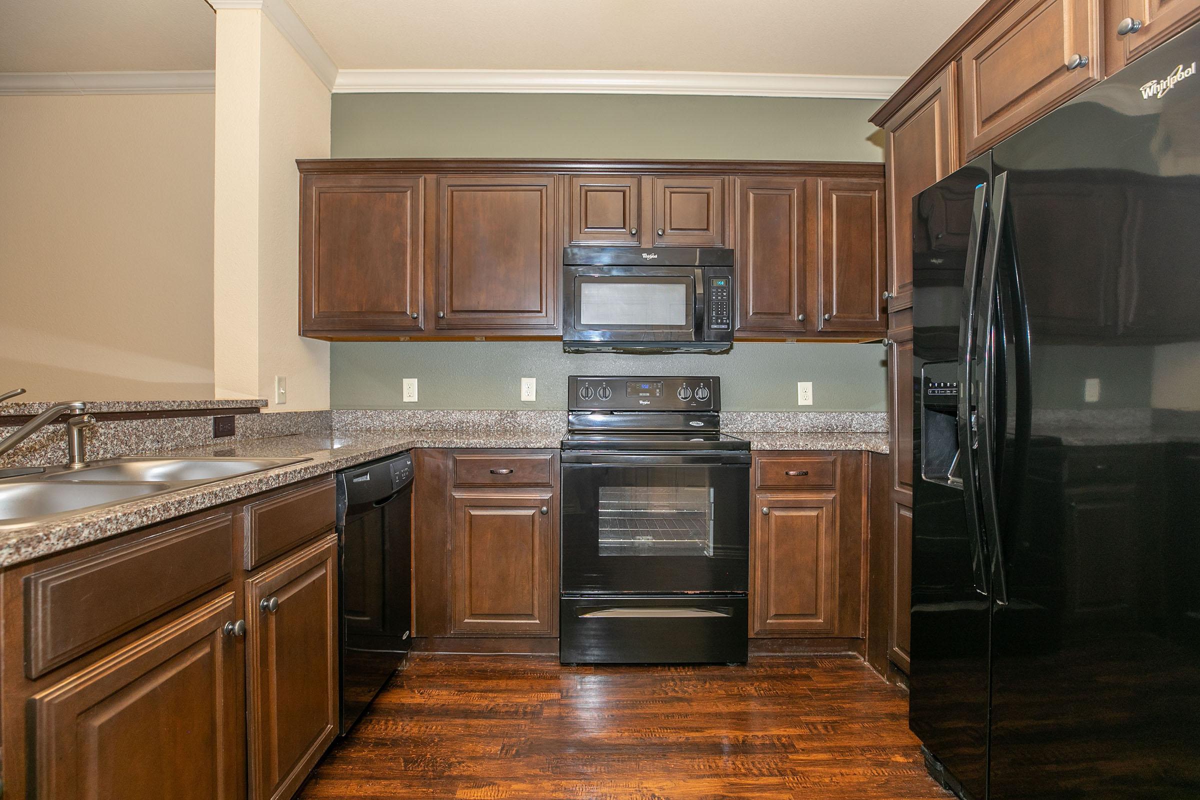 a kitchen with stainless steel appliances and wooden cabinets