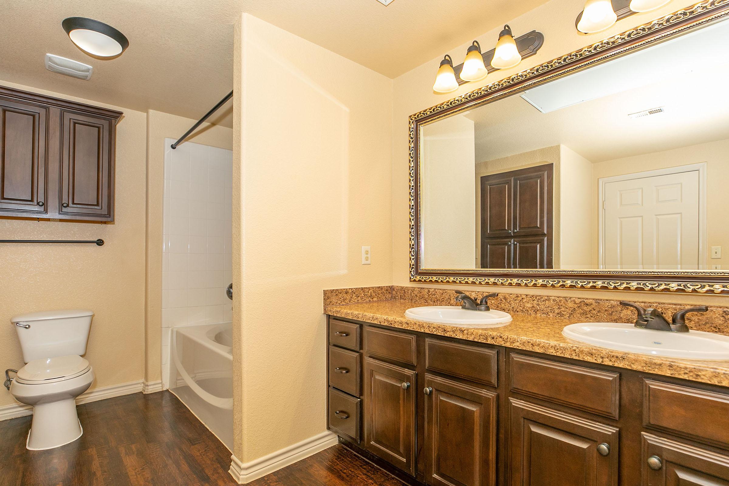 a kitchen with a sink and a mirror