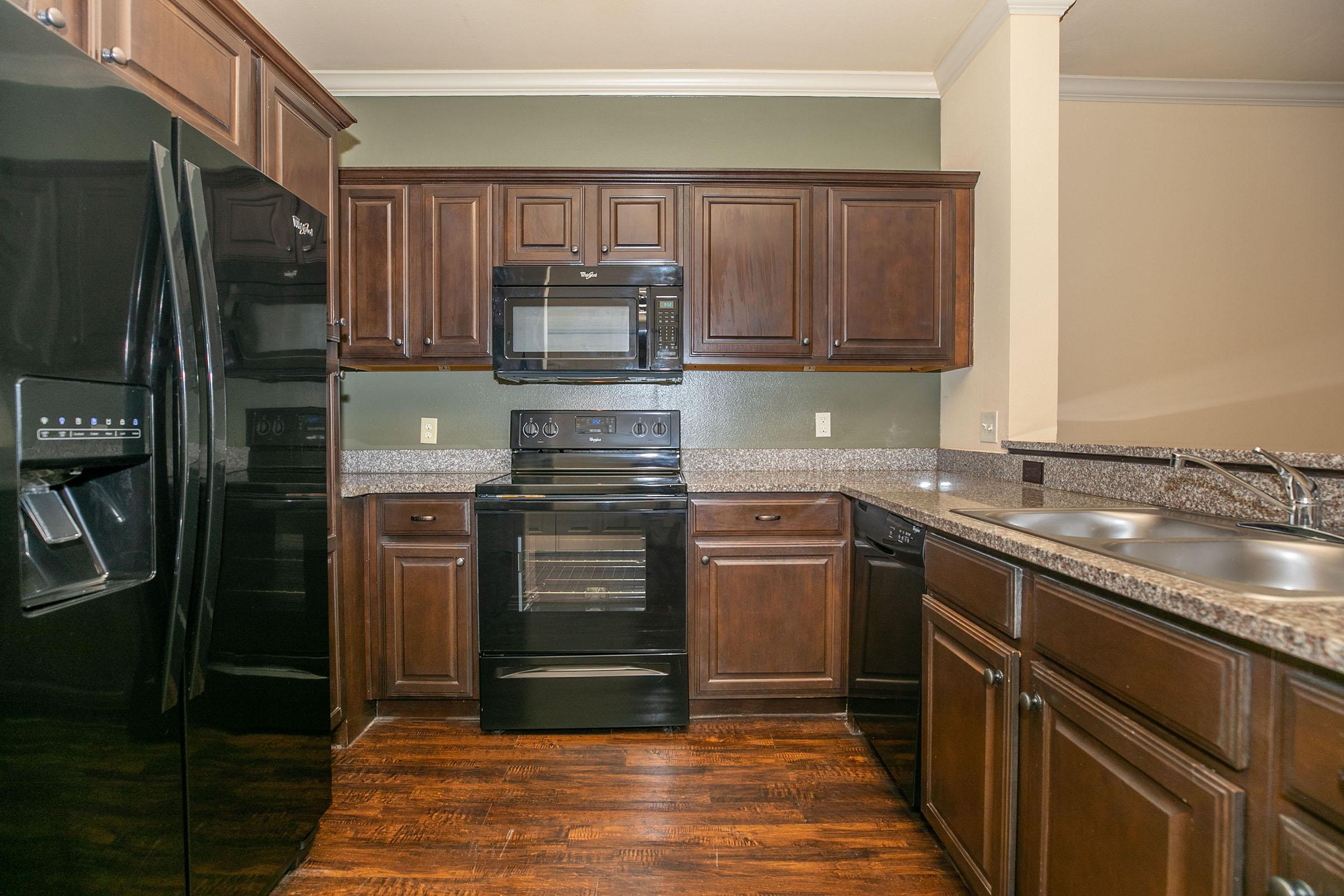 a kitchen with stainless steel appliances and wooden cabinets