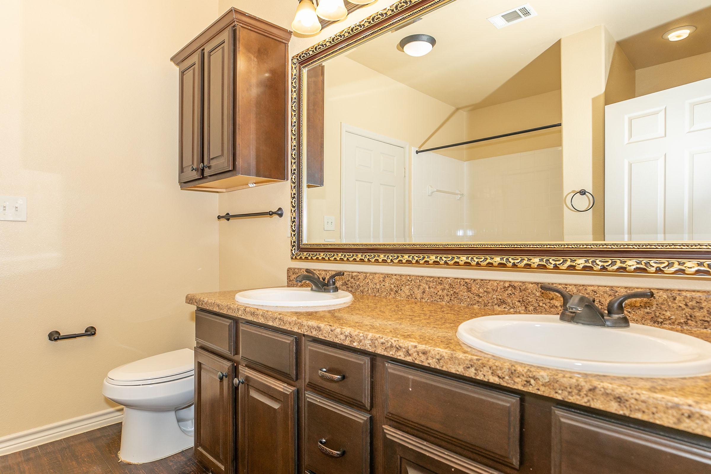 a kitchen with a sink and a mirror