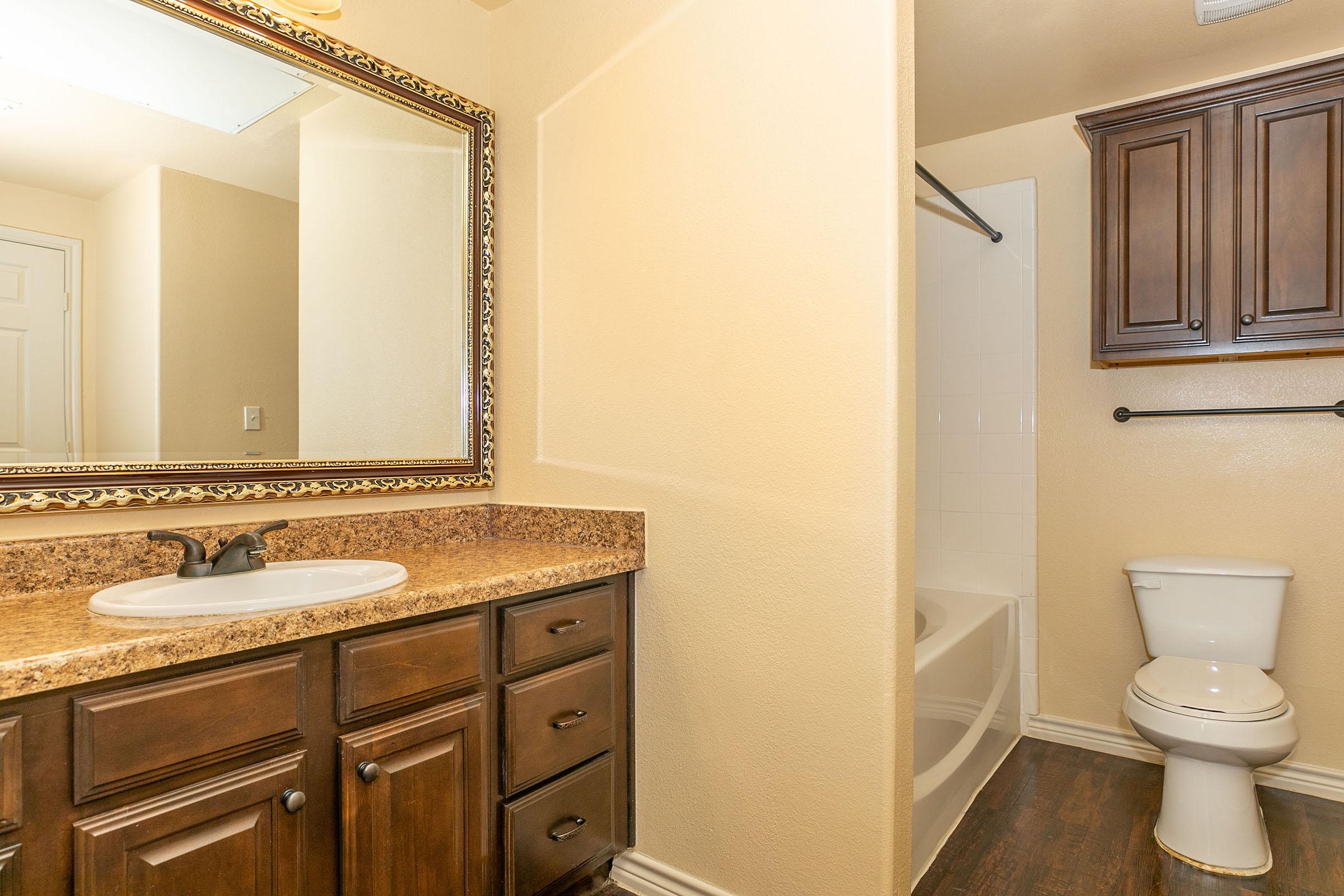 a kitchen with a sink and a mirror