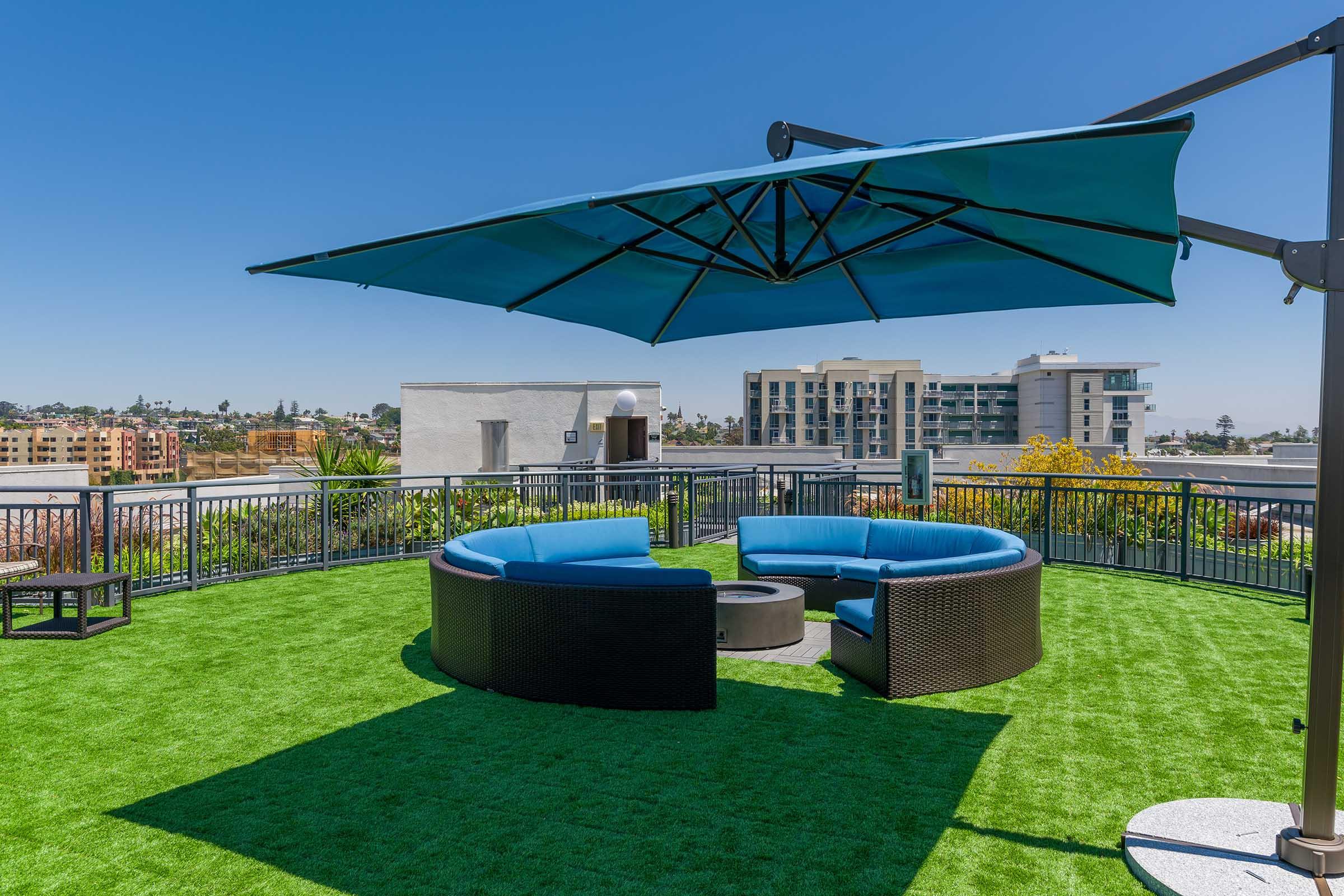 outdoor couch with a blue umbrella