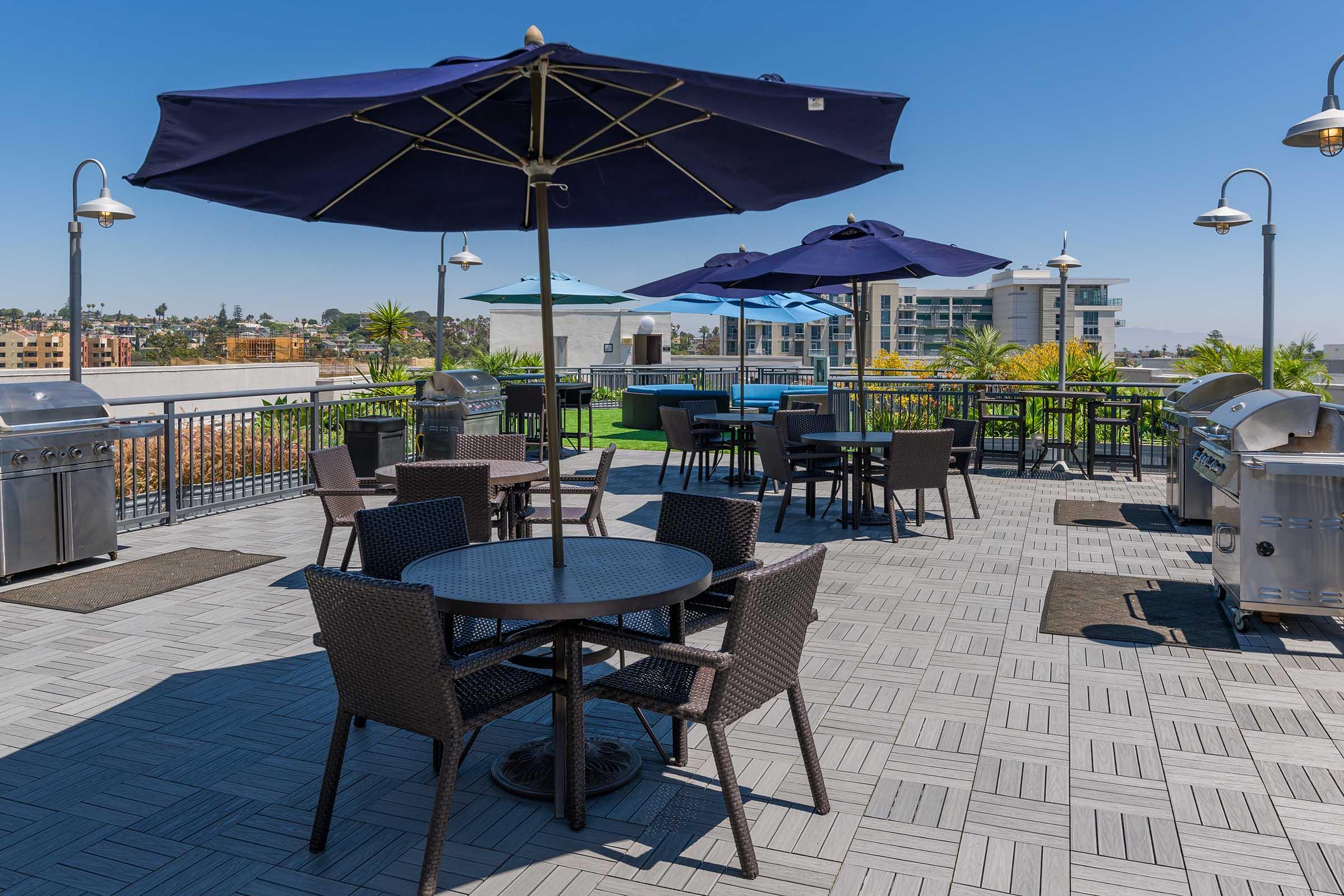 rooftop deck with tables and barbecue