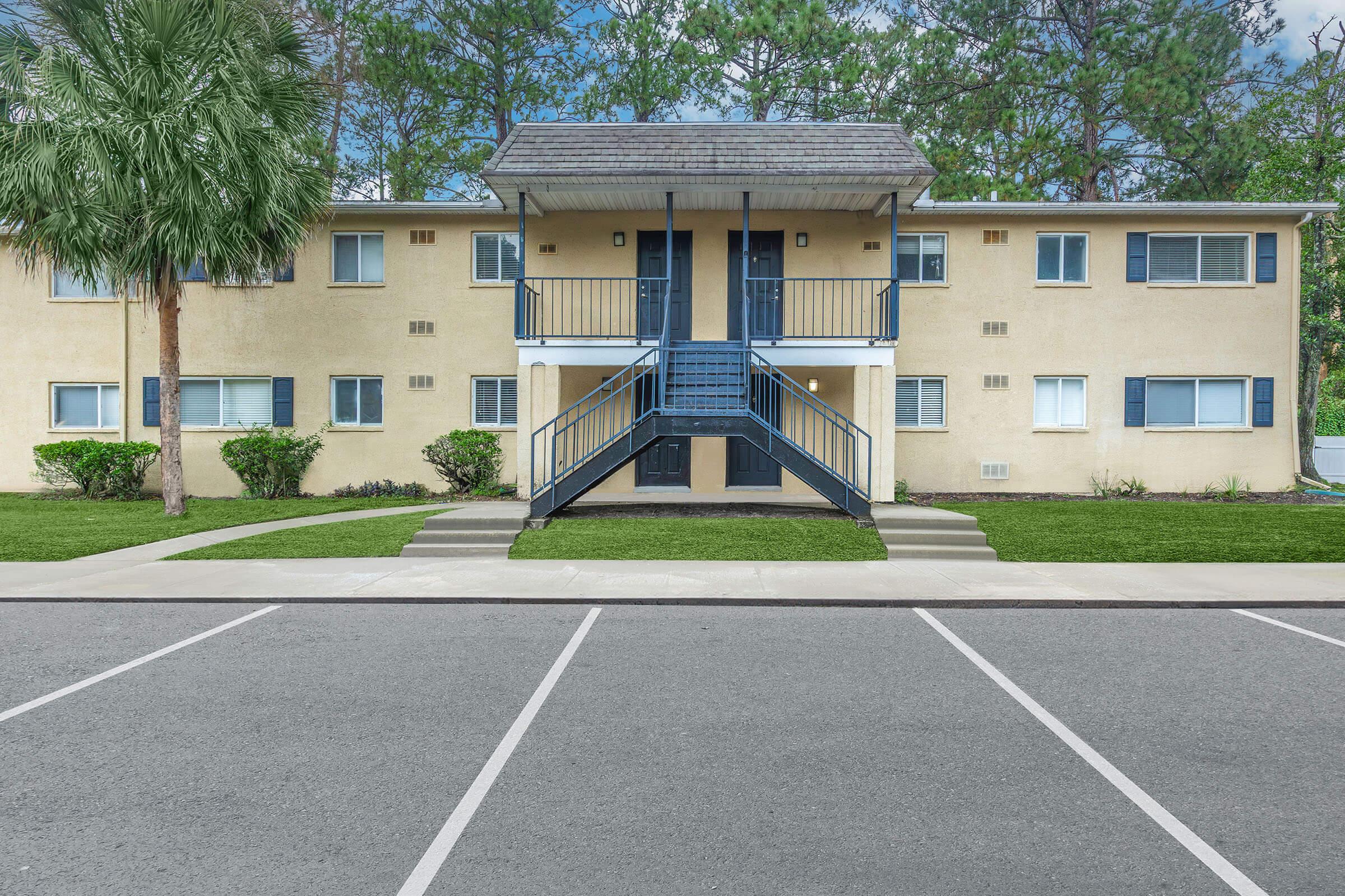 an empty parking lot in front of a house