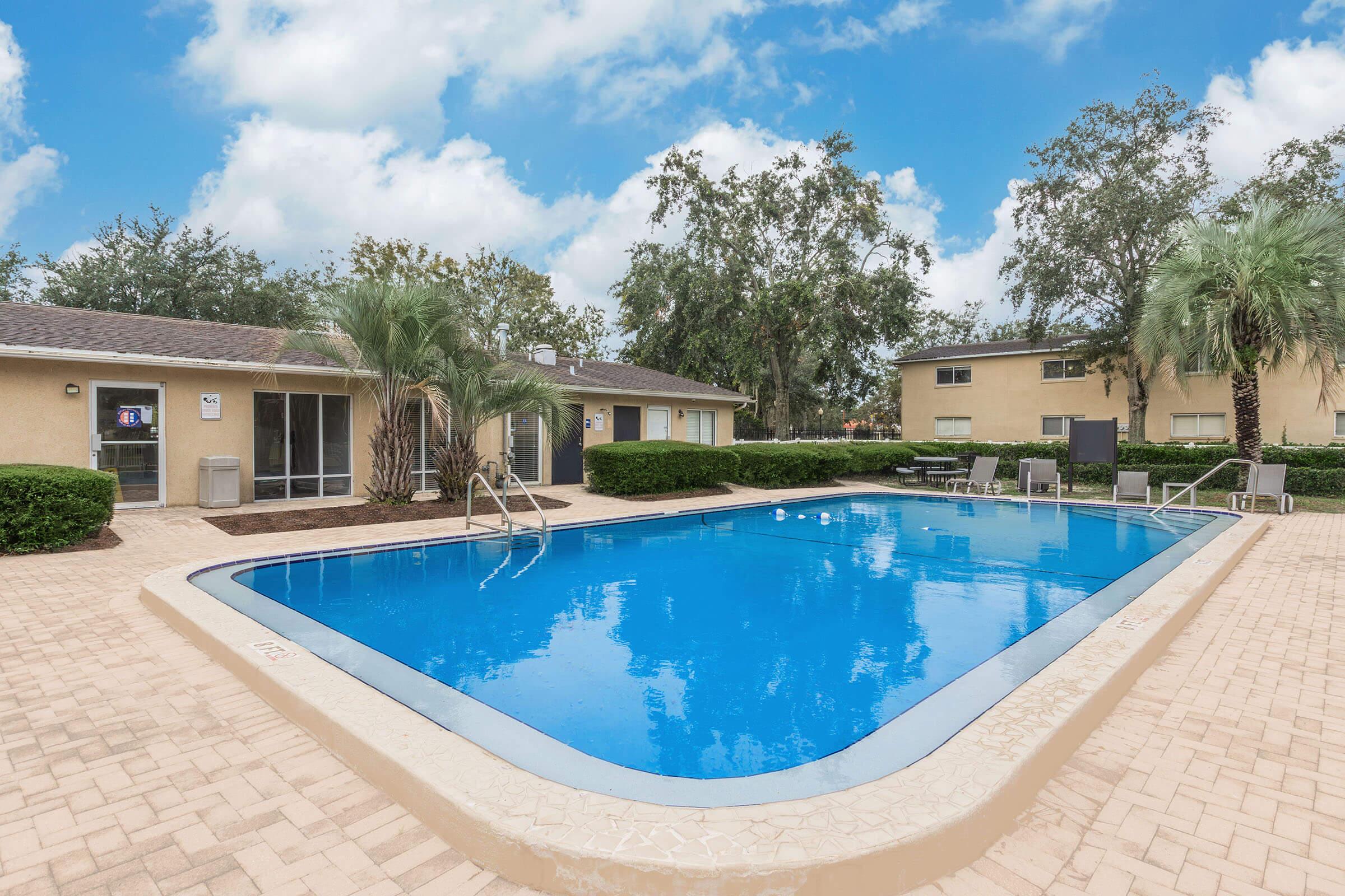 a house with a pool outside of a building