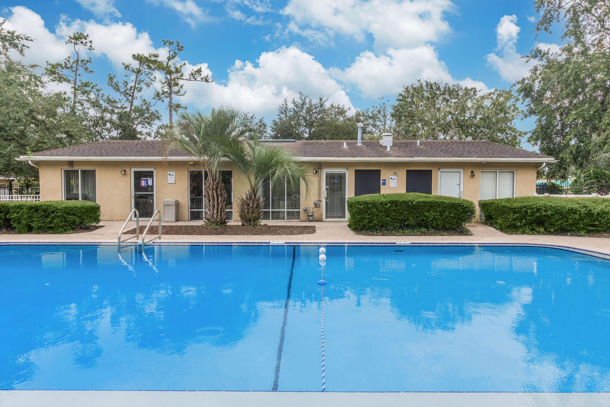 a large pool of water in front of a house