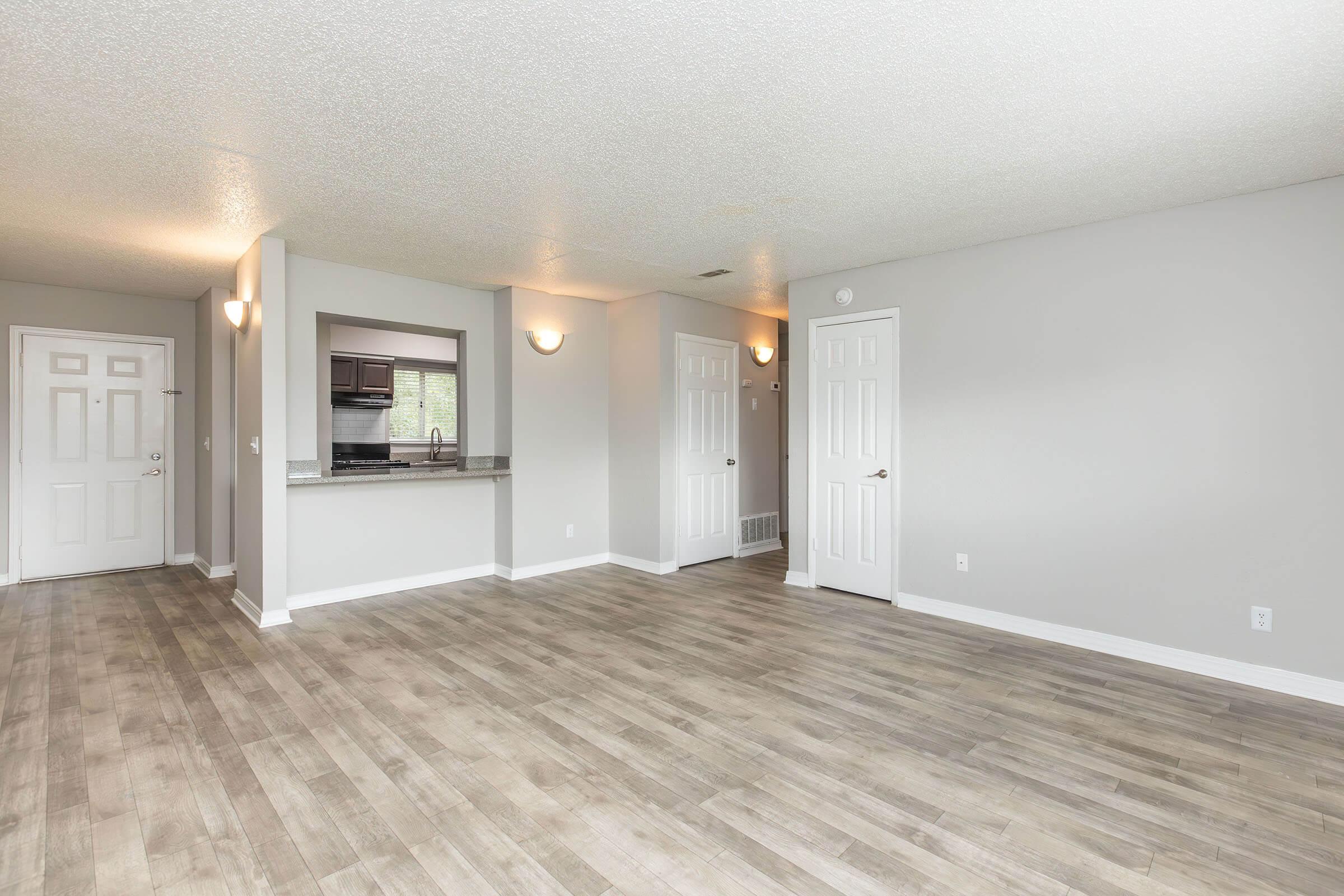 a large empty room with a wood floor