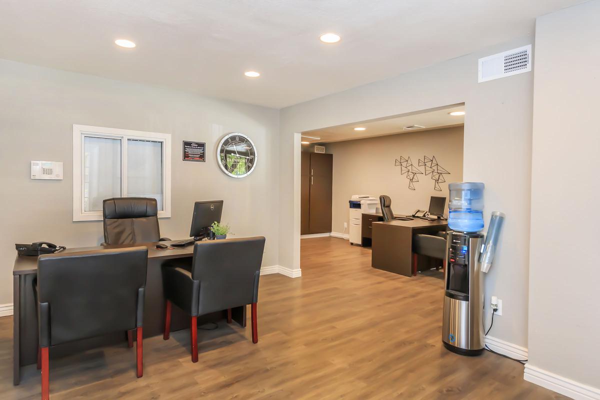 a living room filled with furniture and a refrigerator