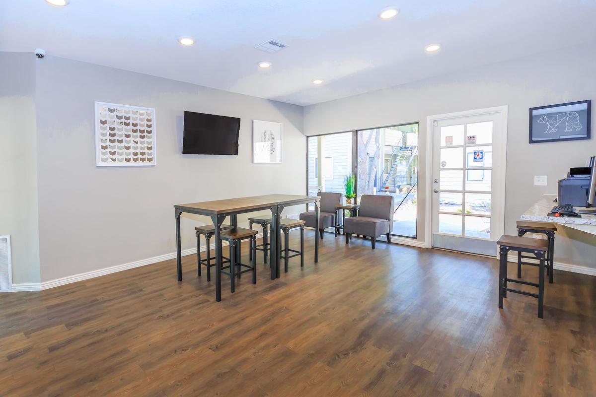 a living room filled with furniture on top of a hard wood floor