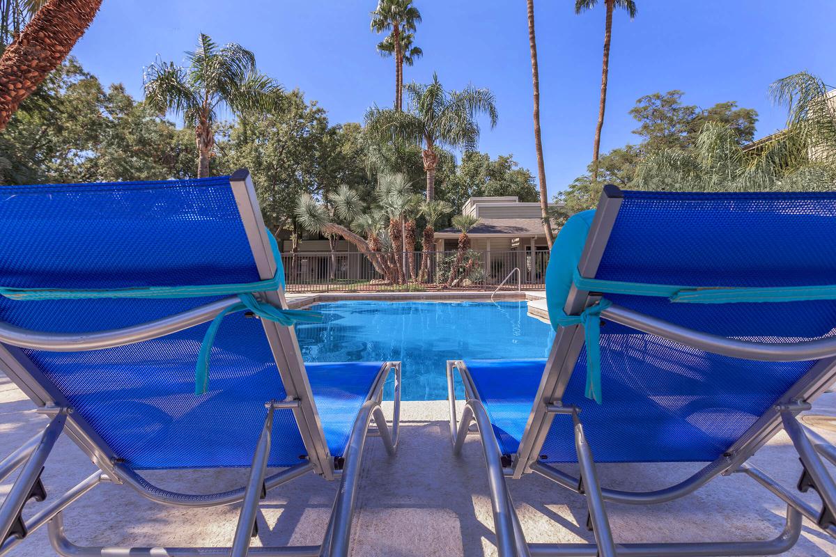 a couple of lawn chairs sitting on top of a blue chair