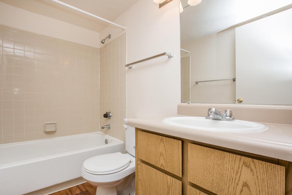 a white tub sitting next to a sink