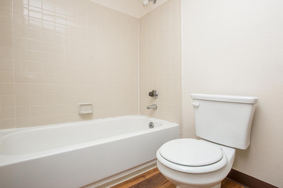 a white tub sitting next to a sink